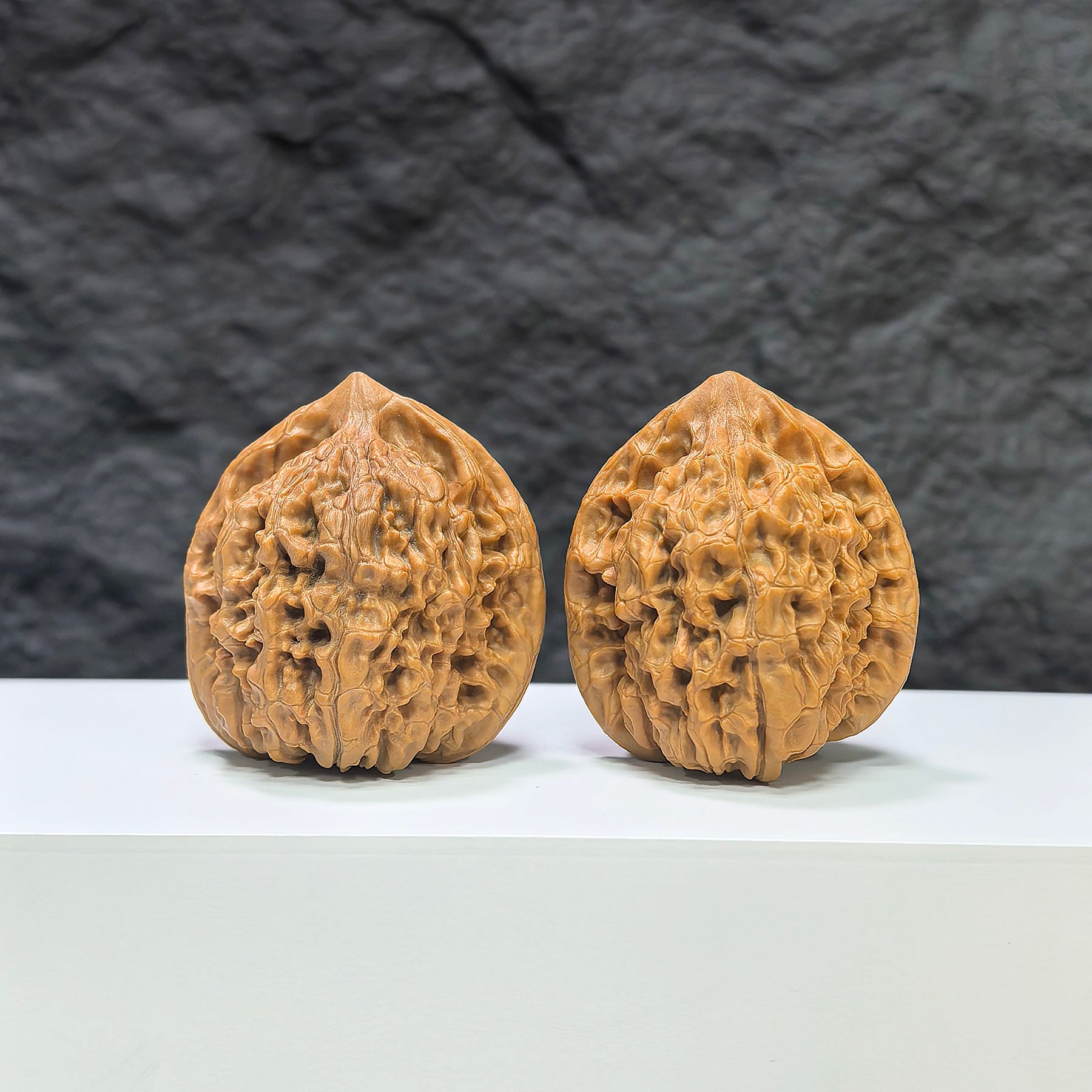 Pair of Wenwan Art Kylin Texture Classic Wenwan Walnuts, 39mm x 35mm, with intricate 麒麟紋 pattern and smooth polished surface.