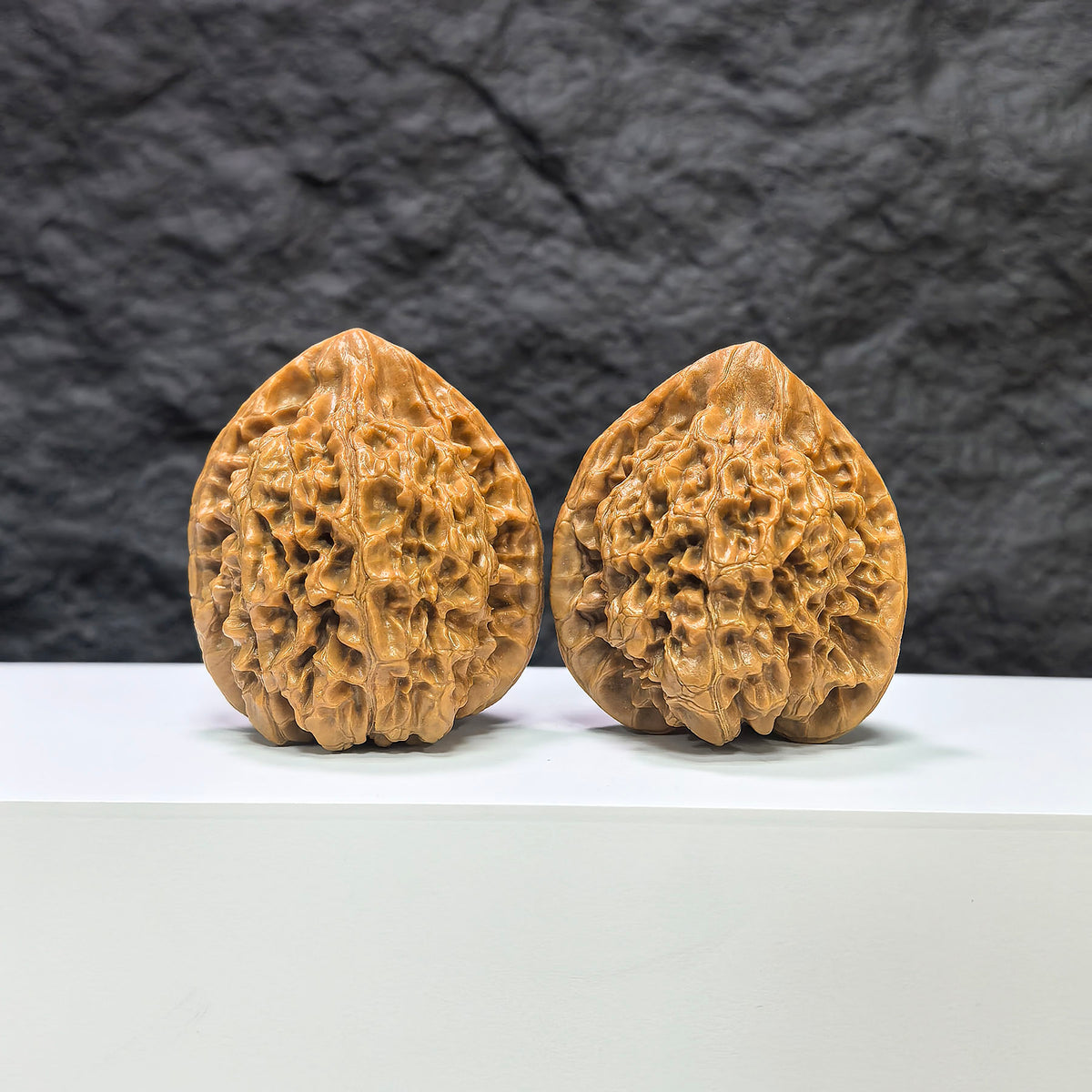 Pair of official Wenwan Art classic Wenwan walnuts with 43mm and 37mm dimensions, showcasing smooth, polished walnut surfaces.