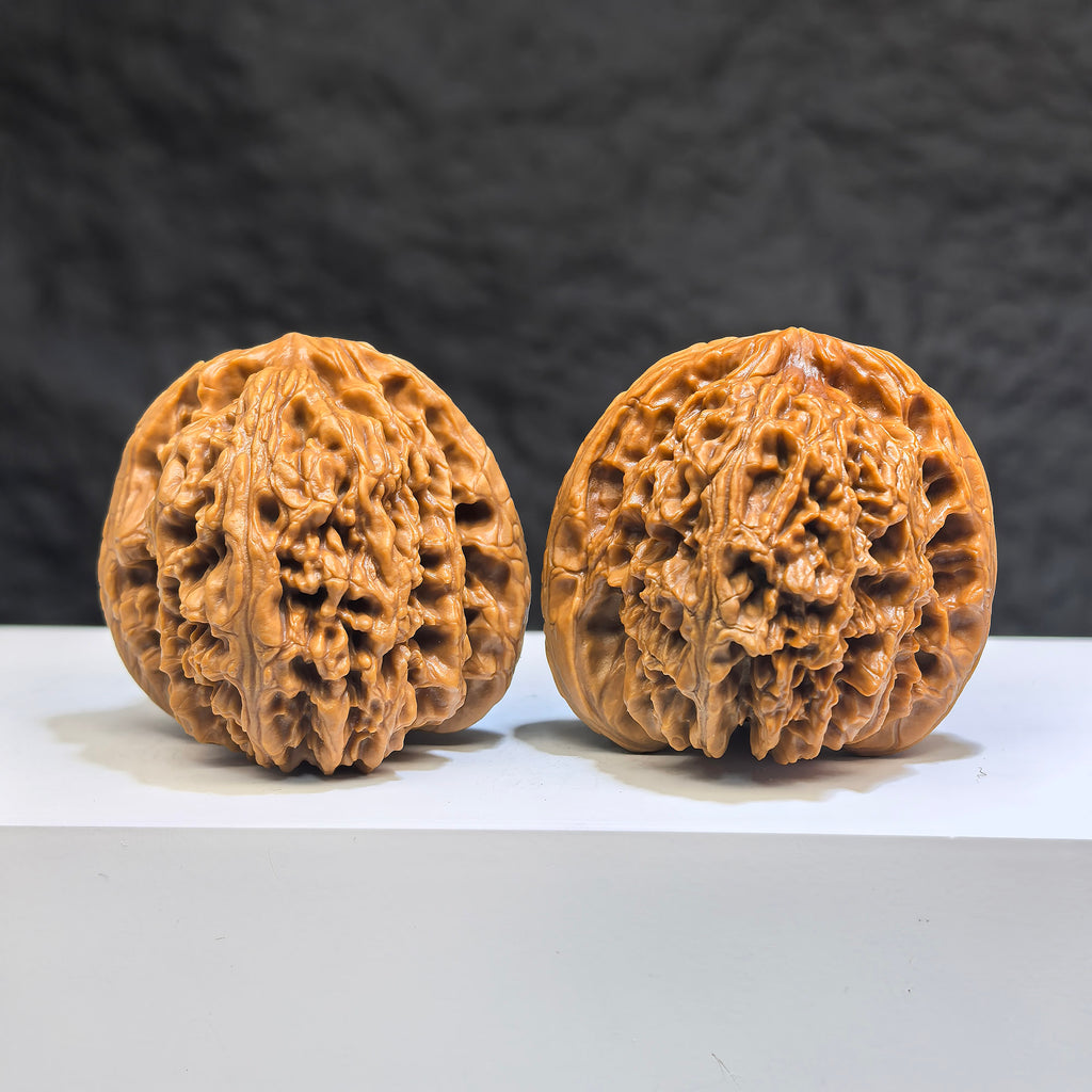 Pair of Wenwan Art Tri-Angular Concave Base Nanjiangstone deep-base Wenwan walnuts, 40mm, featuring distinctive triangular shape and smooth surface.