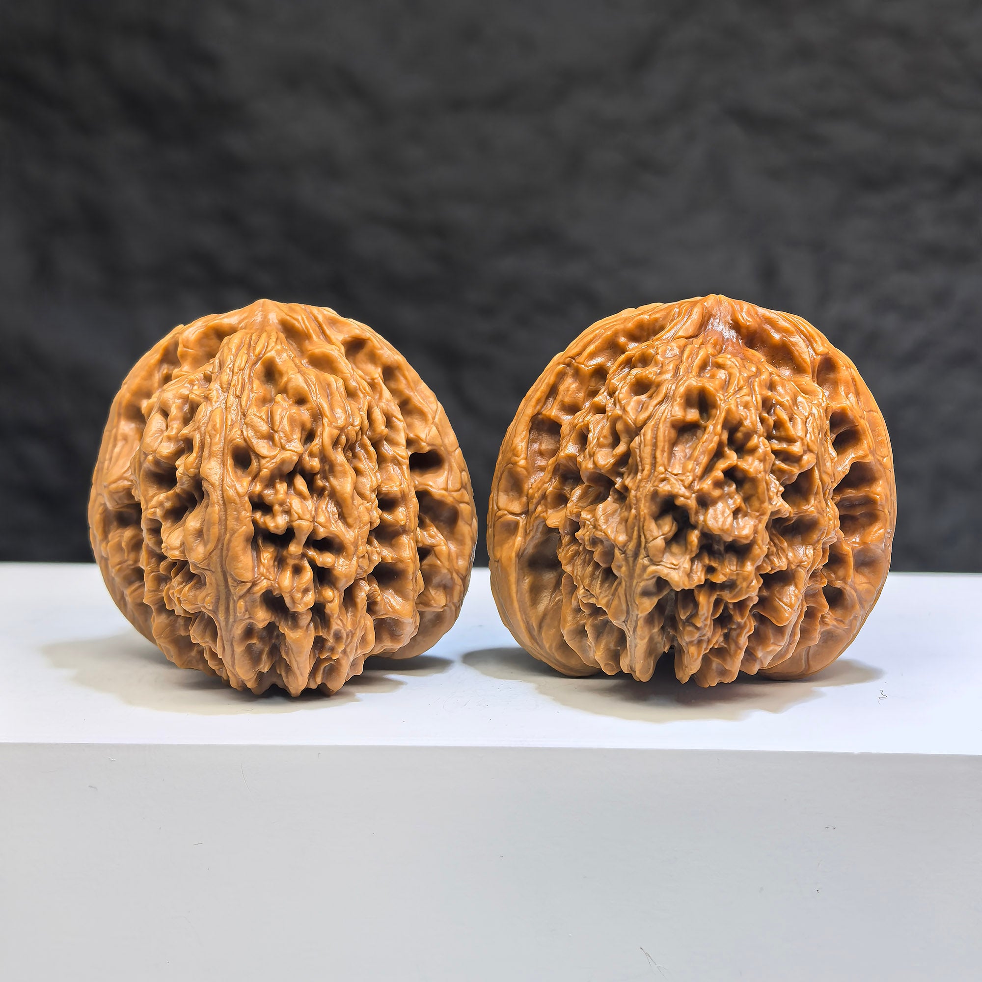 Pair of Wenwan Art Tri-Angular Concave Base Nanjiangstone deep-base Wenwan walnuts, 40mm, featuring distinctive triangular shape and smooth surface.