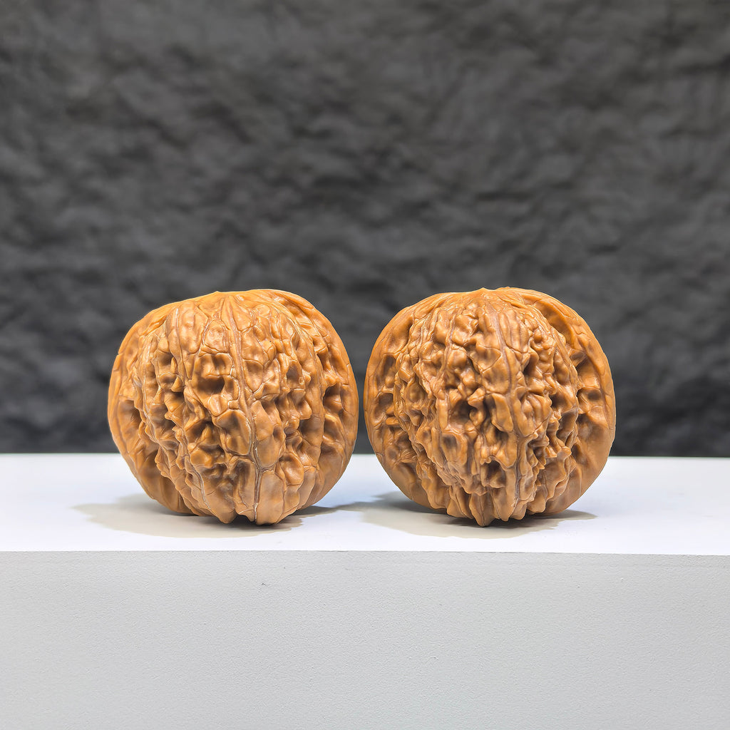 Pair of authentic Wild Millstone Wenwan walnuts from Wenwan Art, 36mm size, showcasing natural wood grain and textured surfaces.