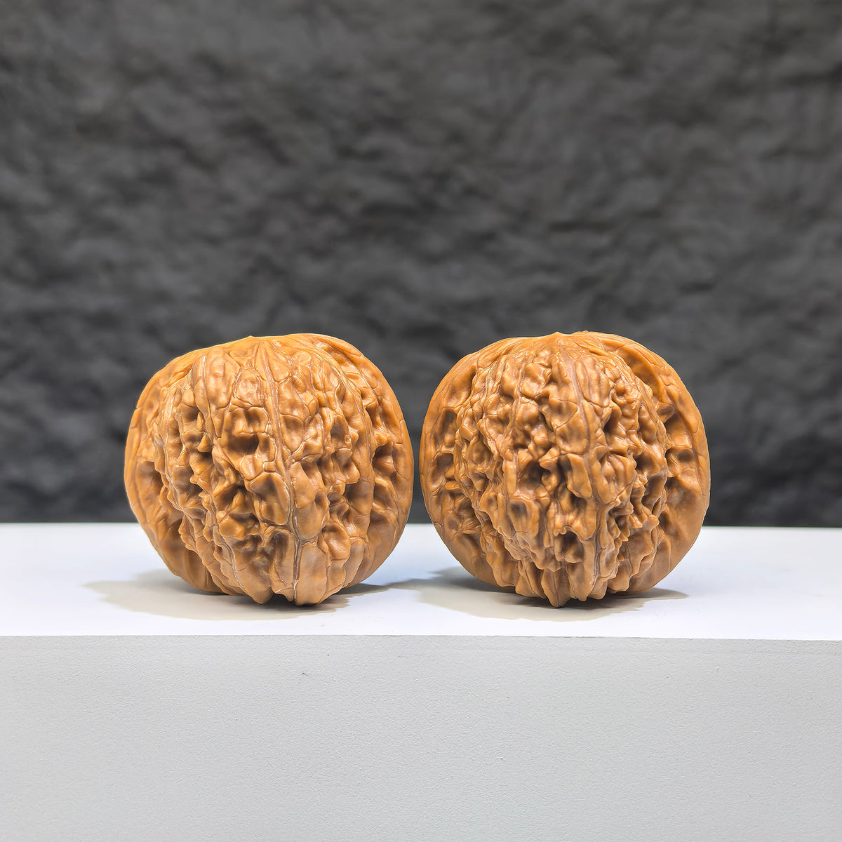Pair of authentic Wild Millstone Wenwan walnuts from Wenwan Art, 36mm size, showcasing natural wood grain and textured surfaces.