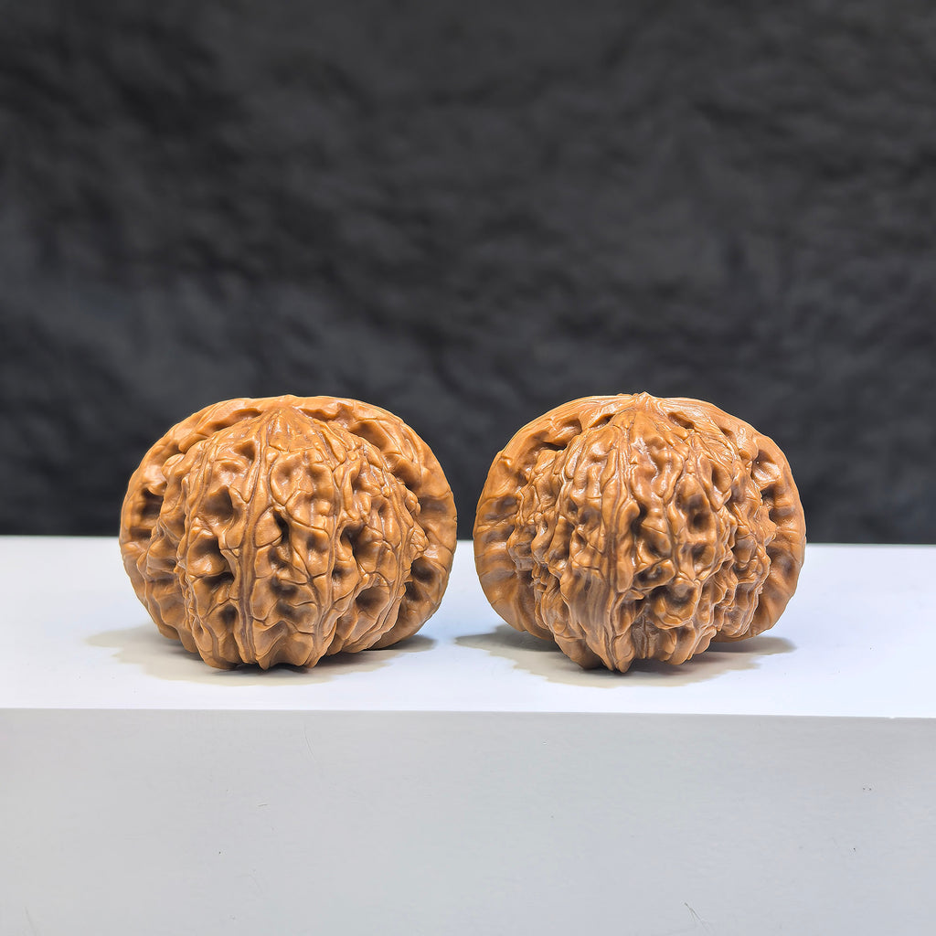Pair of spherical white lion Wenwan walnuts by Wenwan Art, 35mm round-profile carved white lion sculptures for collection.