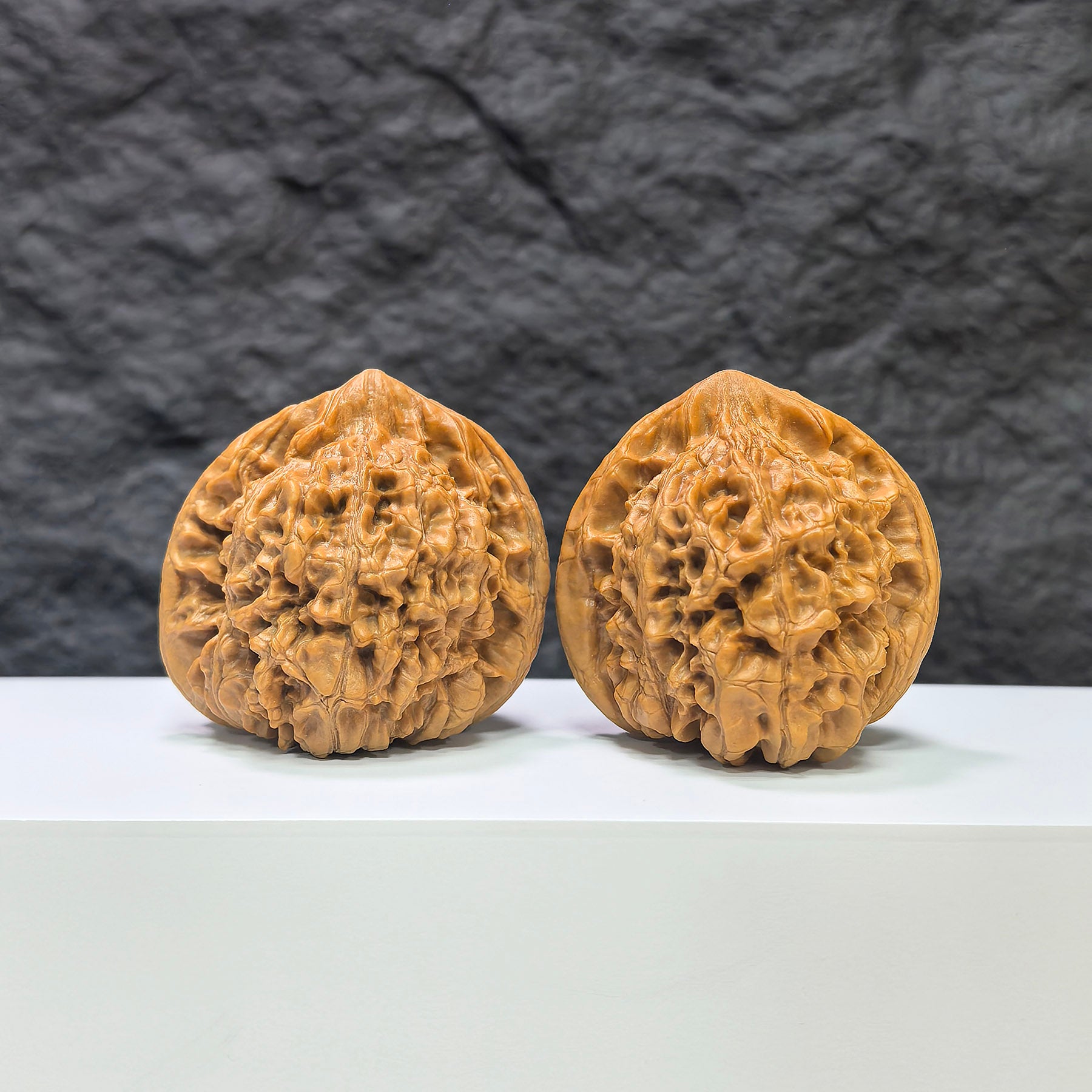 Pair of large Wenwan Art official Wenwan walnuts, 47mm x 42mm, showcasing smooth, polished walnut shells in natural tones.