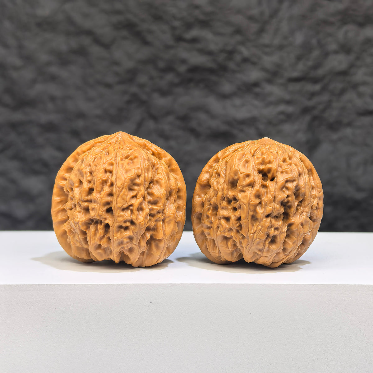 Pair of Wenwan Art Pocket Yuhua Stone miniatures, 34mm x 33mm, featuring intricate Wenwan walnut carvings.