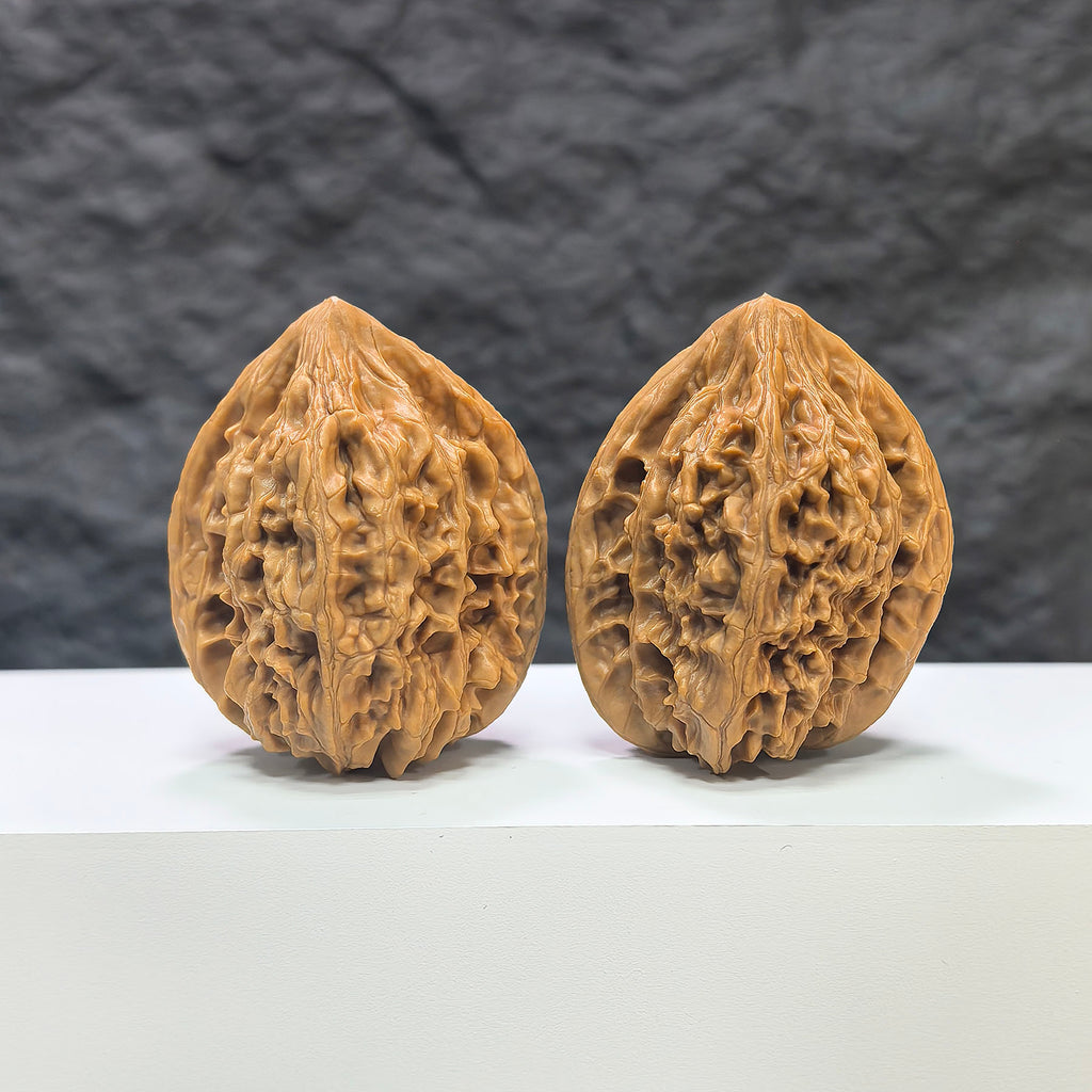 Pair of Beijing Chicken Heart Wenwan walnuts by Wenwan Art, 41mm, featuring smooth, rounded walnut shells with intricate natural patterns.