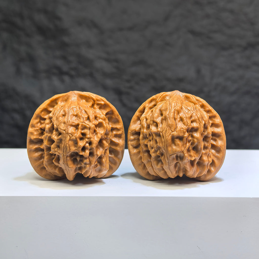 Pair of Wild Wolf Yelang Deep-Carved Wenwan Walnuts from Wenwan Art, 39mm and 37mm, showcasing intricate carvings and natural walnut grain.