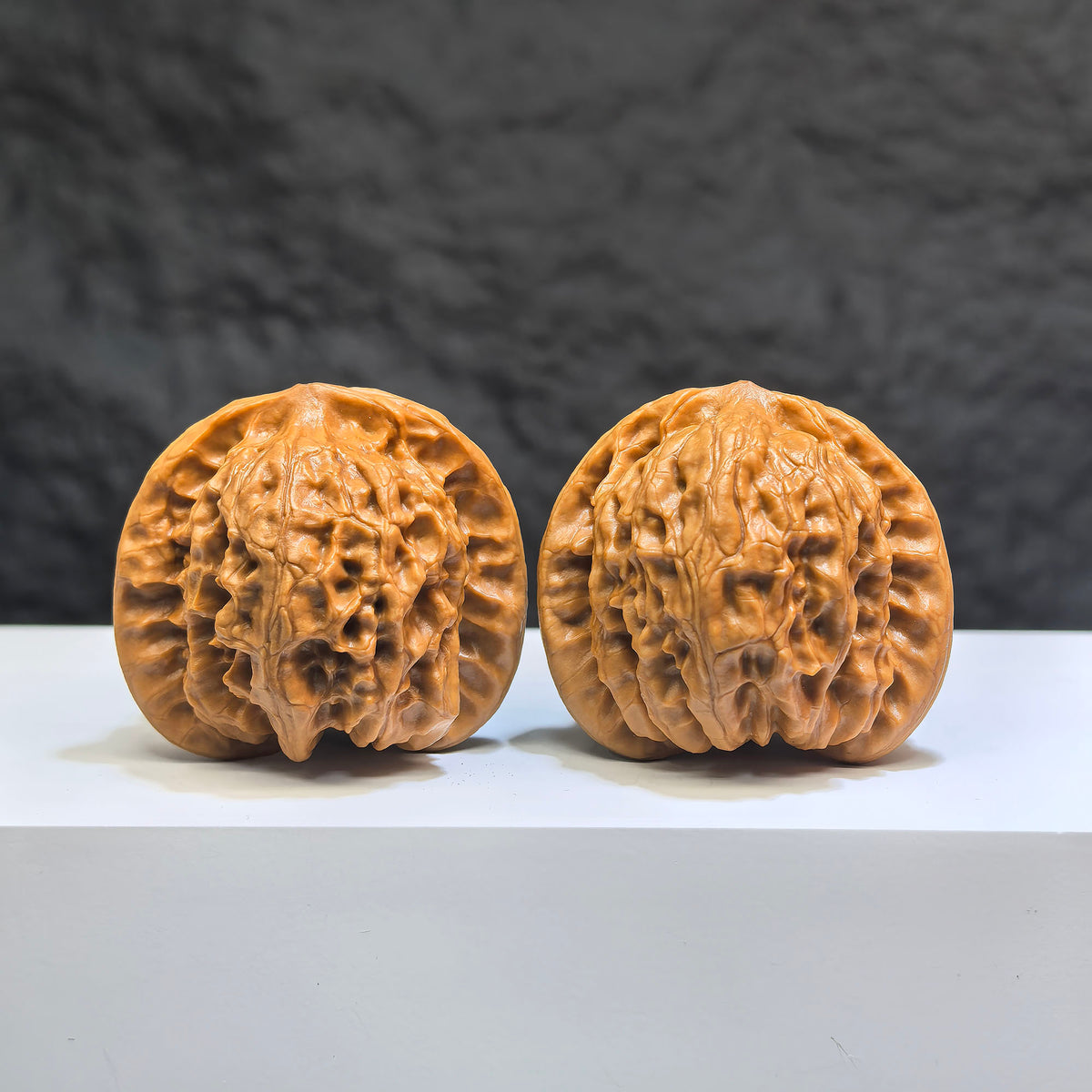 Pair of Wild Wolf Yelang Deep-Carved Wenwan Walnuts from Wenwan Art, 39mm and 37mm, showcasing intricate carvings and natural walnut grain.