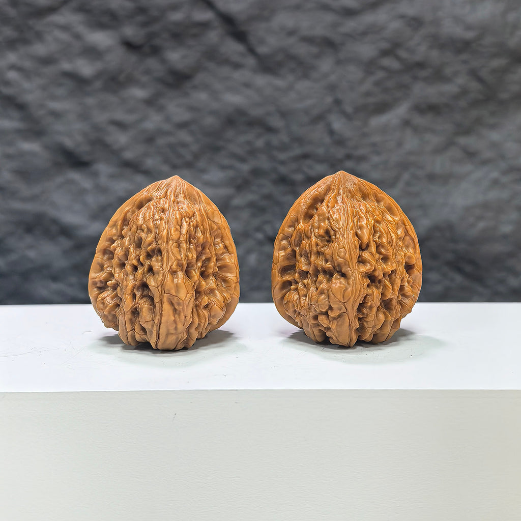 Pair of Pinggu Concave Base Wenwan walnuts from Wenwan Art, deep-base walnuts measuring 33mm x 37mm, natural wood finish.