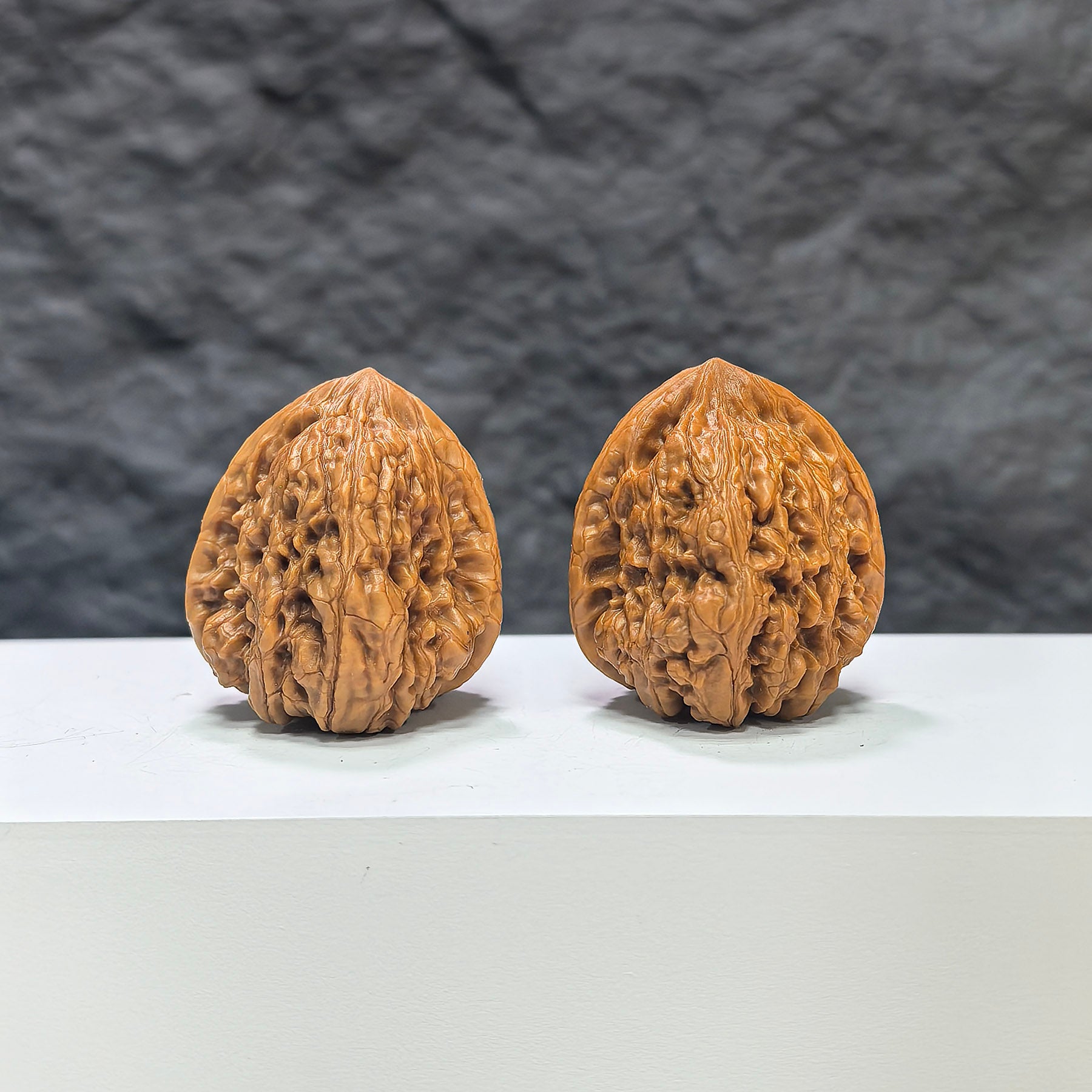 Pair of Pinggu Concave Base Wenwan walnuts from Wenwan Art, deep-base walnuts measuring 33mm x 37mm, natural wood finish.