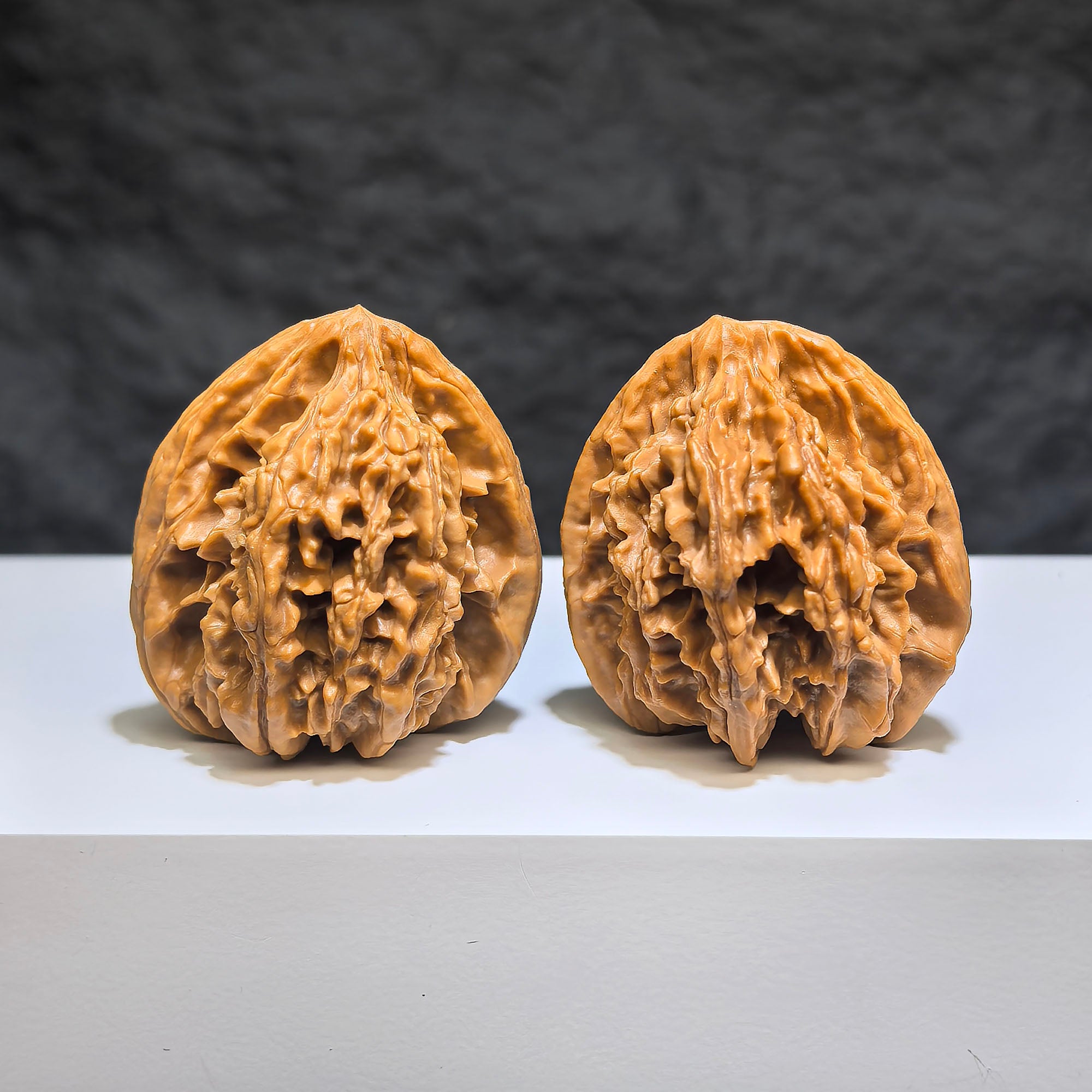 Pair of Tongtian Eight Wenwan walnuts from Wenwan Art, 36mm x 35mm, showcasing smooth polished walnut surfaces.