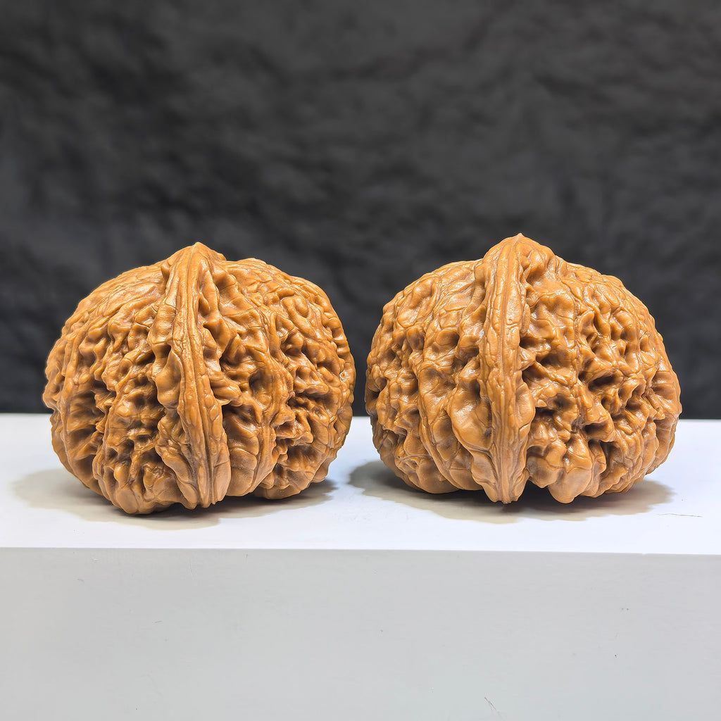 Pair of spherical Wenwan walnuts made from Nanjiangstone, 41mm and 43mm, displayed side by side, showcasing smooth round profiles.