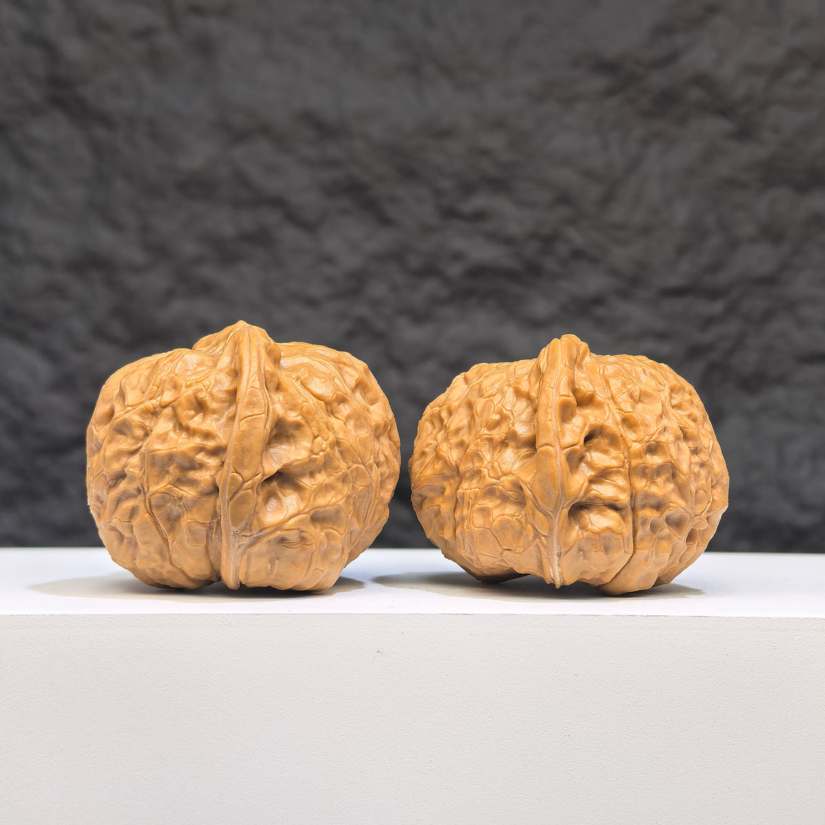 Pair of Small Pumpkin Pier Wenwan Walnuts from Wenwan Art, miniature walnut carvings measuring 39mm by 42mm.
