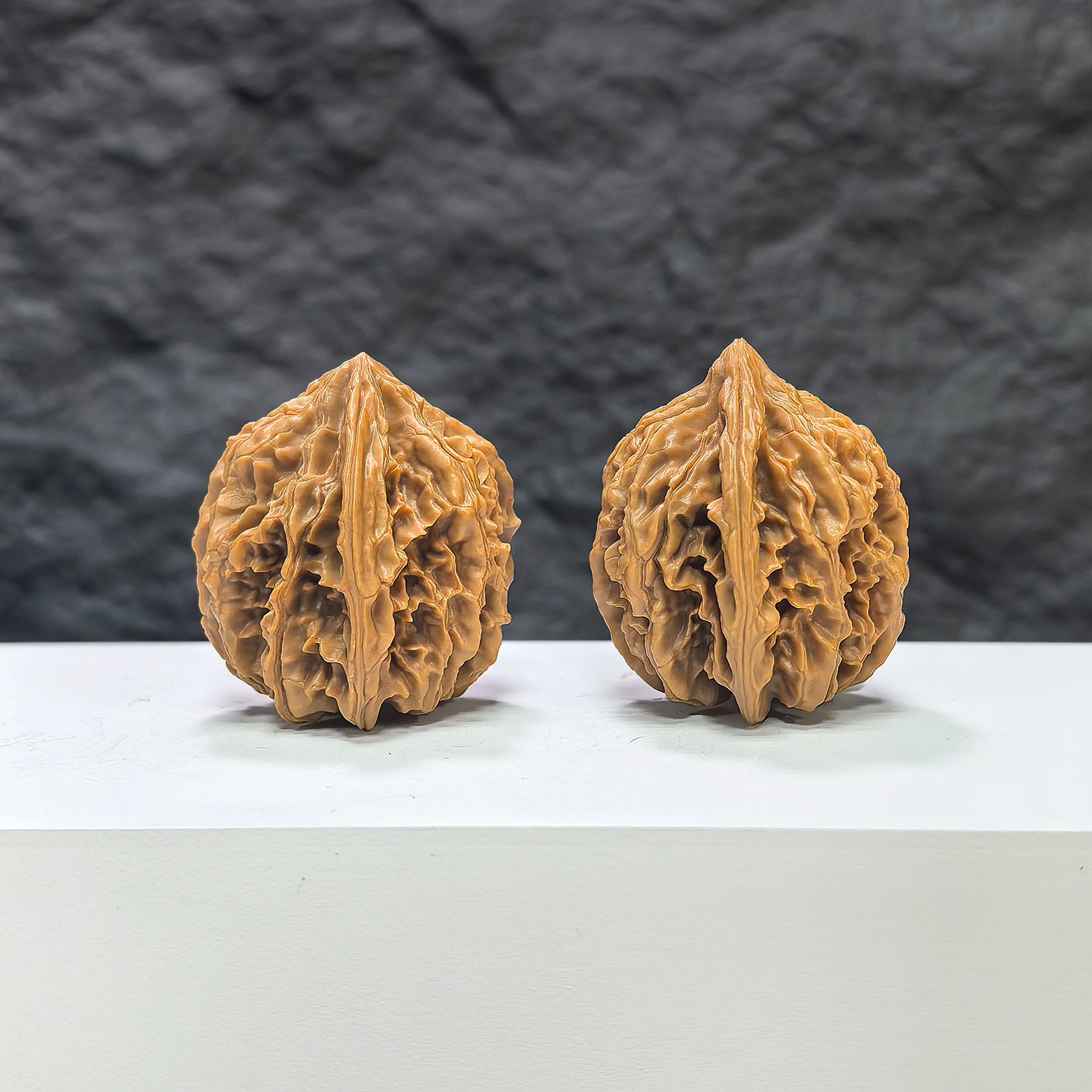 Pair of Tongtian Eight classic Wenwan walnuts from Wenwan Art, featuring detailed carvings and 33mm diameter in natural walnut wood