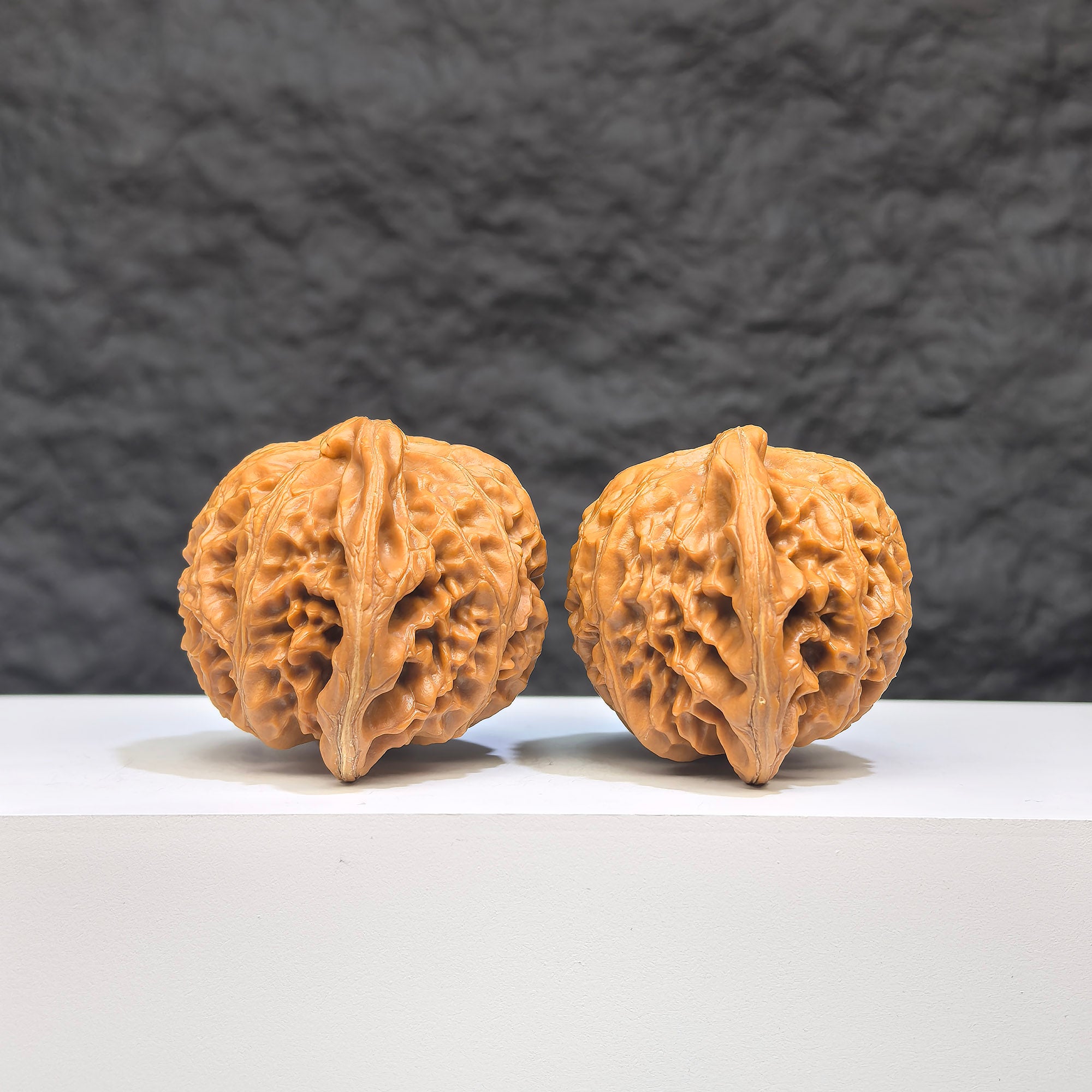 Pair of Palace Lantern Wenwan Walnuts from Wenwan Art, featuring intricate carvings and a glossy finish, measuring 44mm by 38mm.