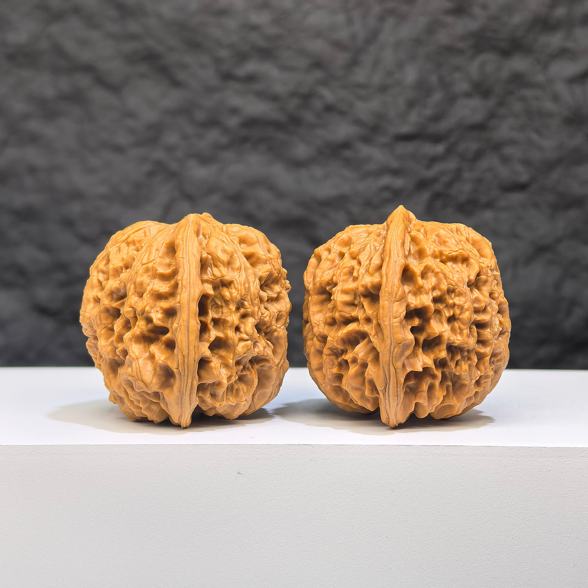 Yuhua Stone Wenwan Walnut pair from Wenwan Art, classic 37mm x 34mm walnuts with natural stone texture and intricate carvings.