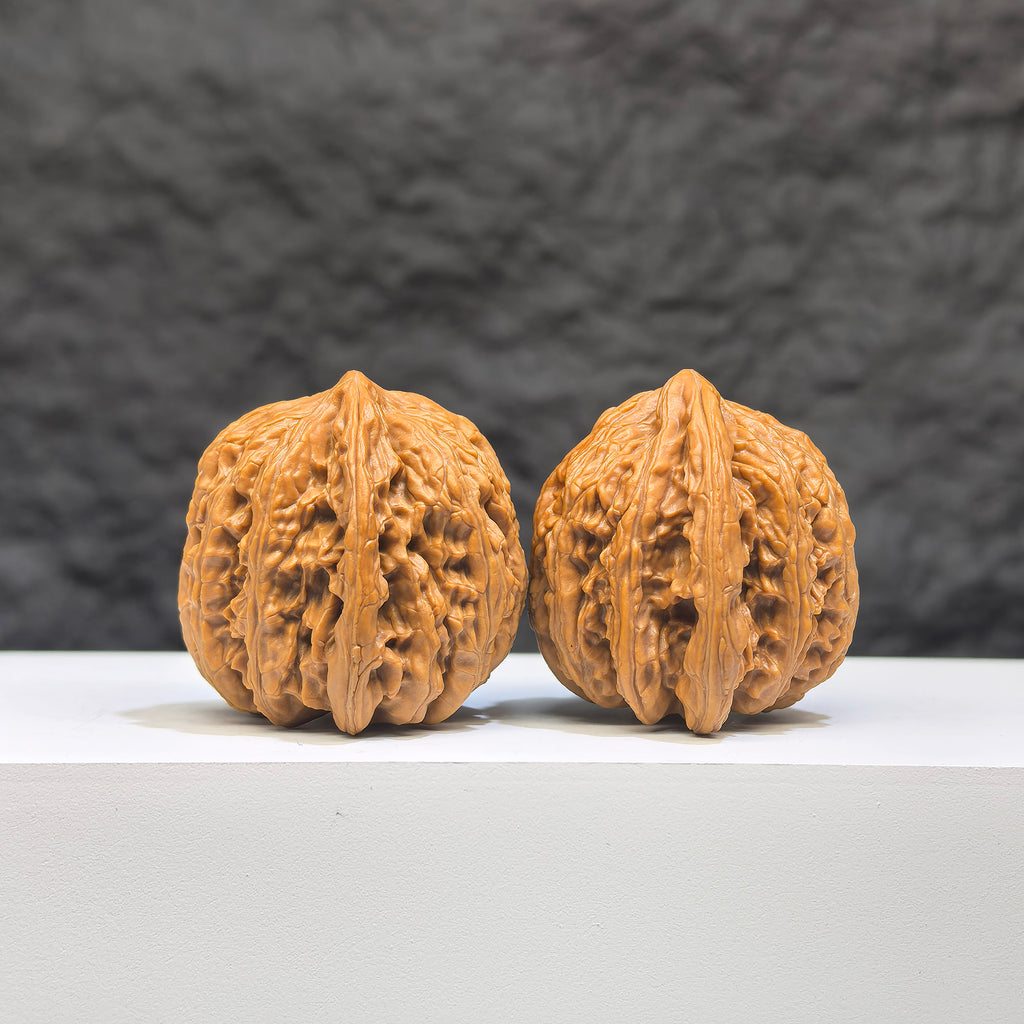 Pair of Peach Heart Concave Base Ruby Wenwan walnuts from Wenwan Art, featuring deep-base design and vibrant red gemstone accents.