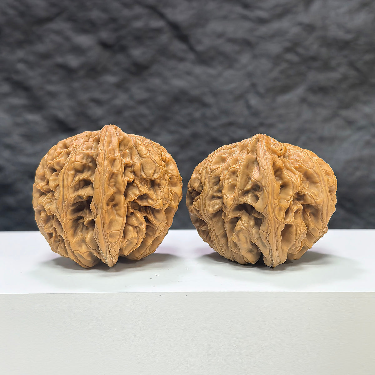 Pair of Classic Scholar Wenwan Walnuts by Wenwan Art, handcrafted 45mm hand-matched walnuts with textured surface.