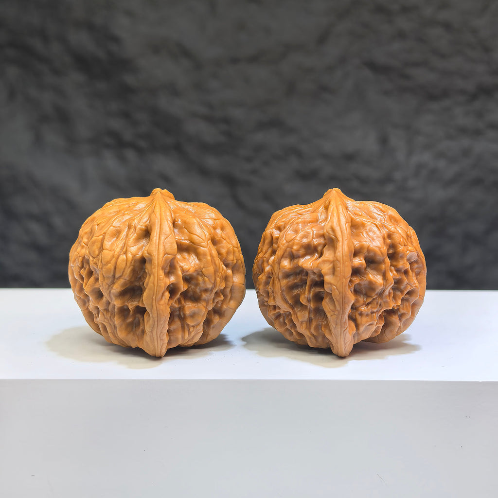 Pair of Wild Wolf Yelang Deep-Carved Wenwan Walnuts from Wenwan Art, featuring intricate carvings and natural walnut appearance.