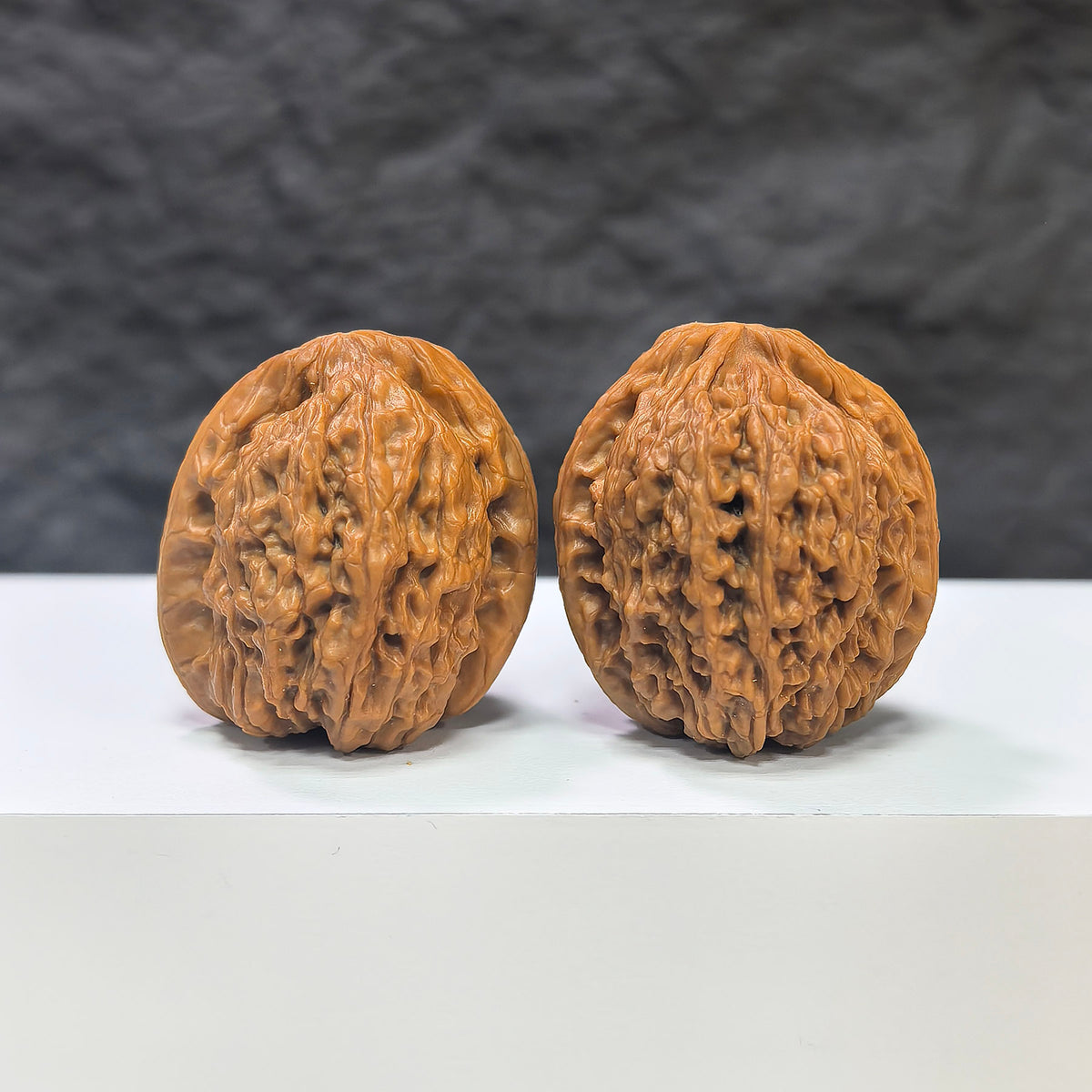 Miniature Wenwan Walnut pair with pocket meteorite accents, crafted by Wenwan Art, measuring 31mm, featuring intricate natural stone details.