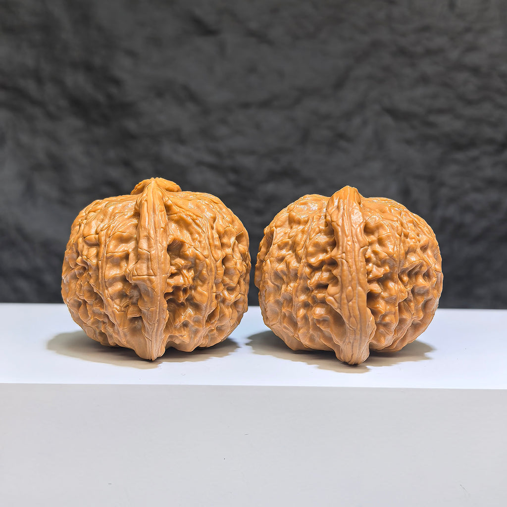 Pair of spherical white lion Wenwan walnuts from Wenwan Art, 43mm and 40mm round-profile decorative walnuts.