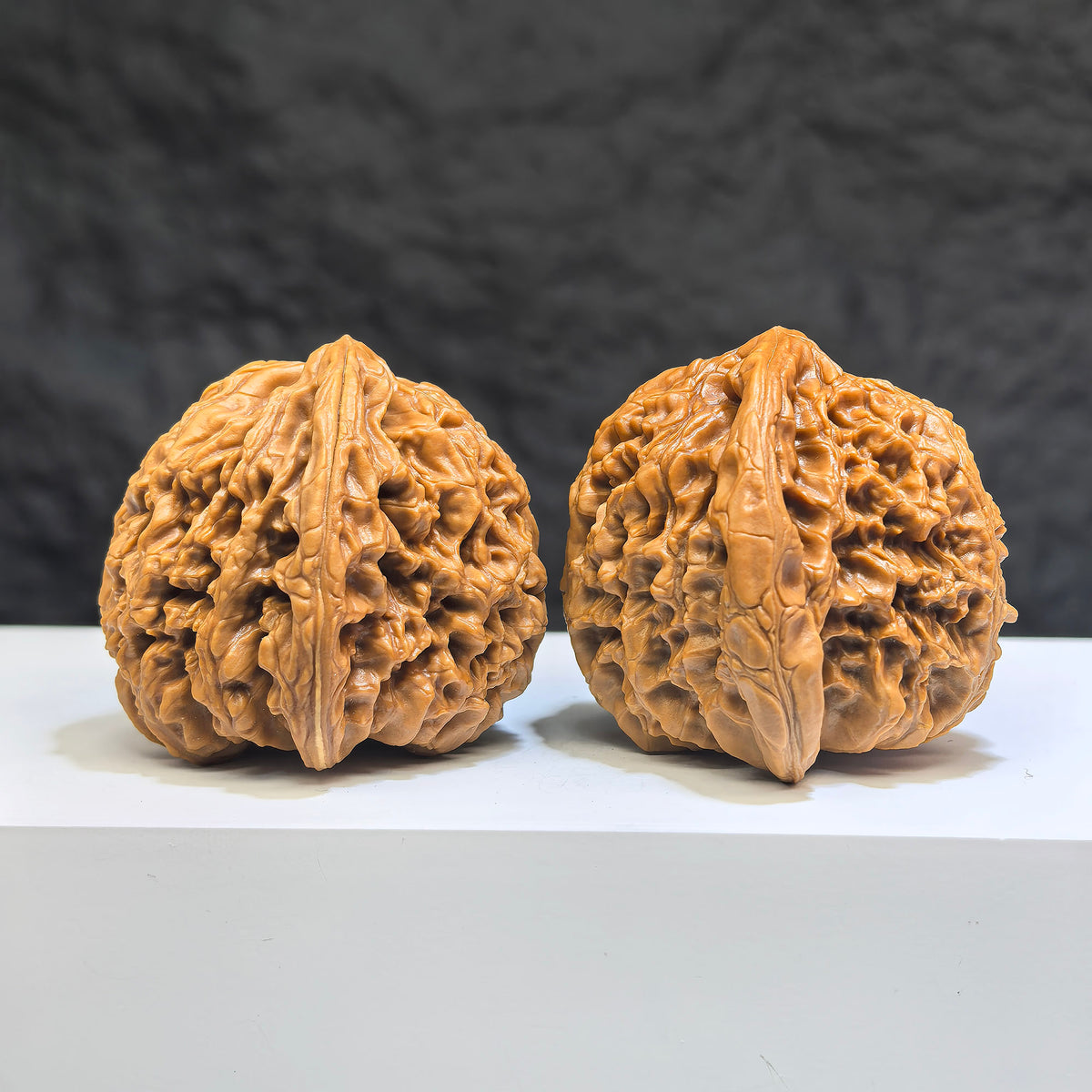 Pair of Wenwan Art Tri-Angular Concave Base Nanjiangstone Wenwan walnuts, 40mm, featuring deep-base design and natural stone texture.