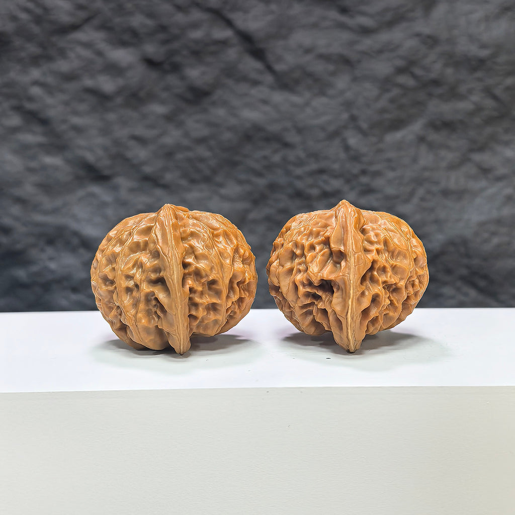 Wenwan Art Classic Scholar Hand-Matched Wenwan Walnut pair, 43mm x 38mm, showcasing detailed craftsmanship and natural wood grain.