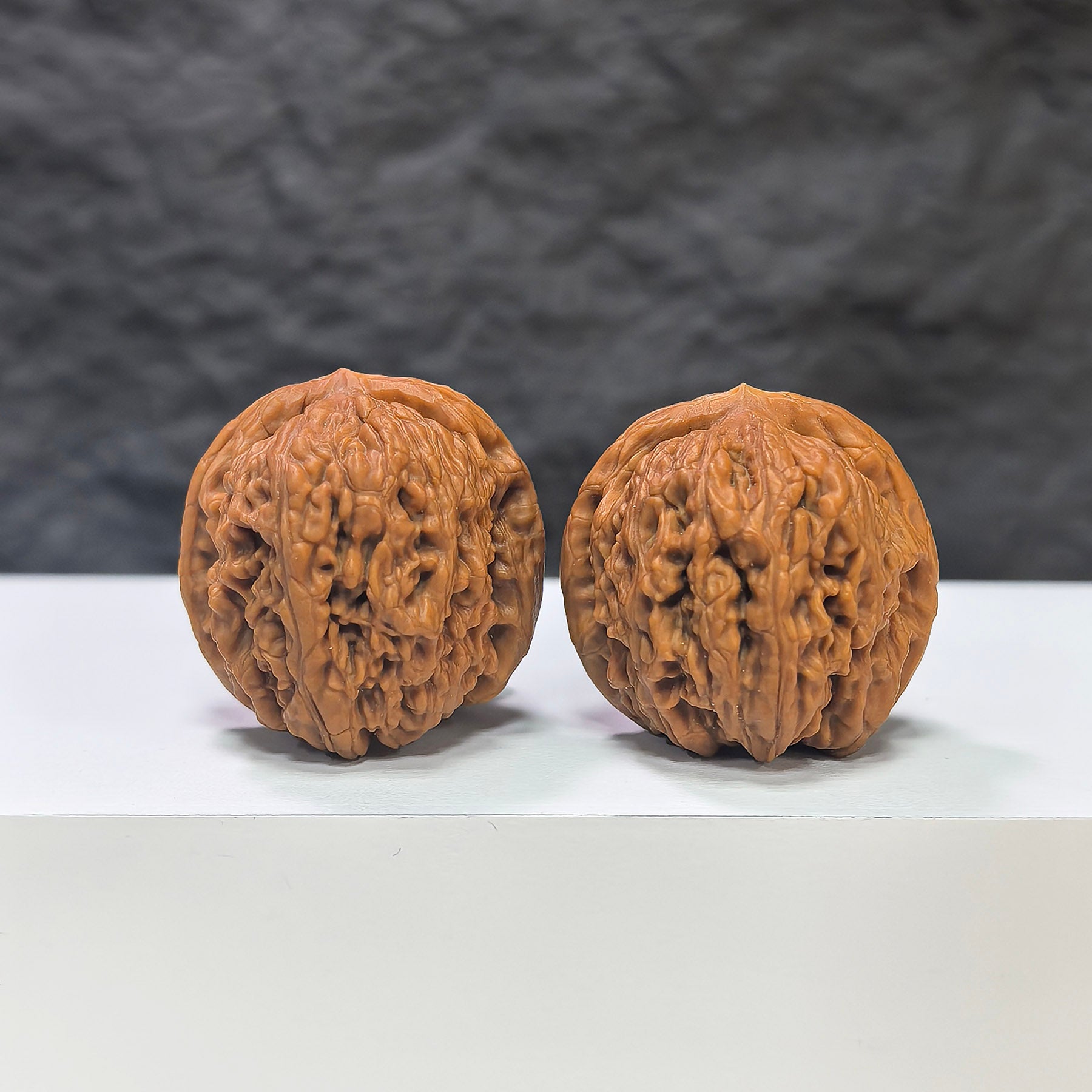 Pair of Meteorite Sycee Wenwan Walnut carvings by Wenwan Art, 30mm size, showcasing detailed natural stone textures.