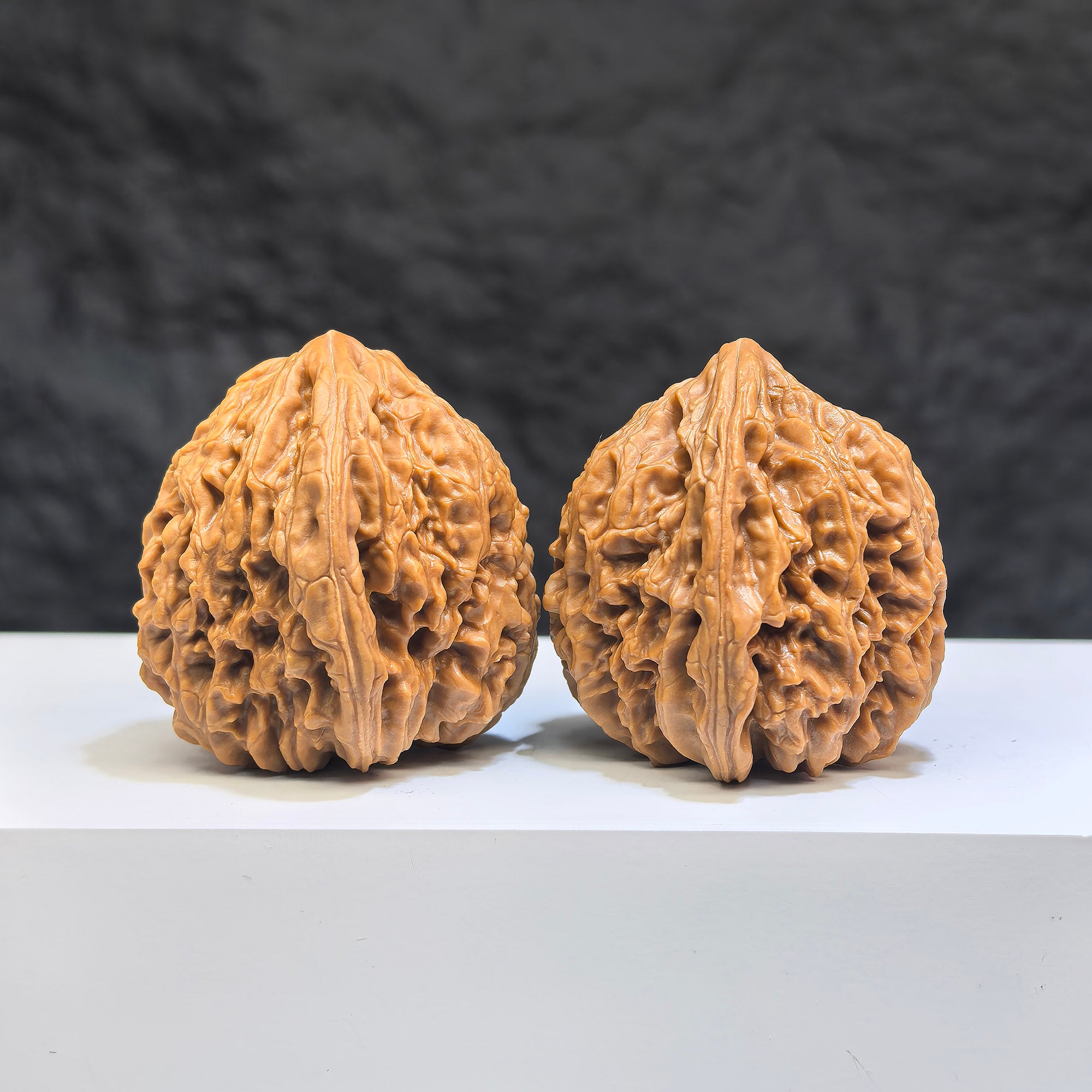 Pair of Nanjiangstone Wenwan walnuts from Wenwan Art, 36mm, showcasing detailed natural stone textures and craftsmanship.