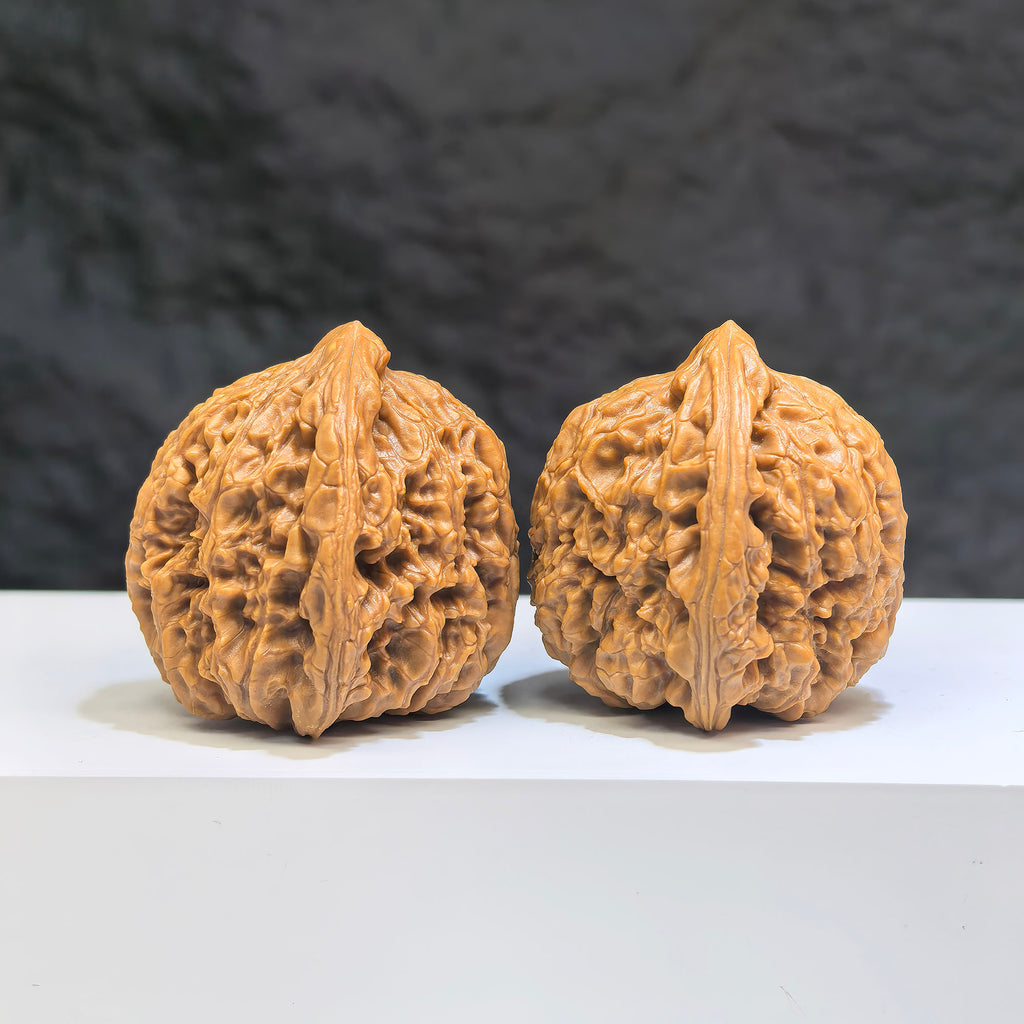 Pair of Nanjiangstone Wenwan walnuts from Wenwan Art, 38mm x 37mm, showcasing detailed natural stone textures and craftsmanship.