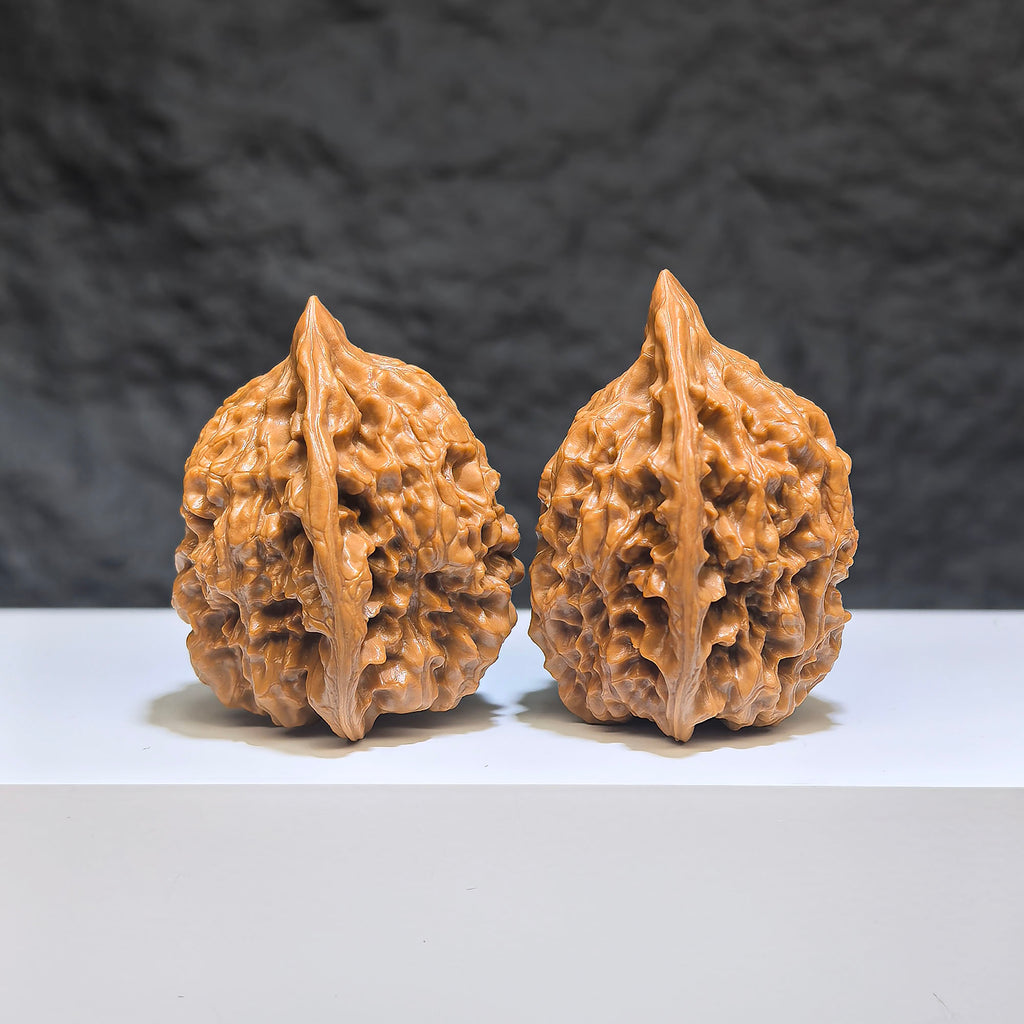 Small Wenwan Art official hat miniature walnut pair, 34mm x 33mm, featuring detailed carving and natural walnut wood grain.