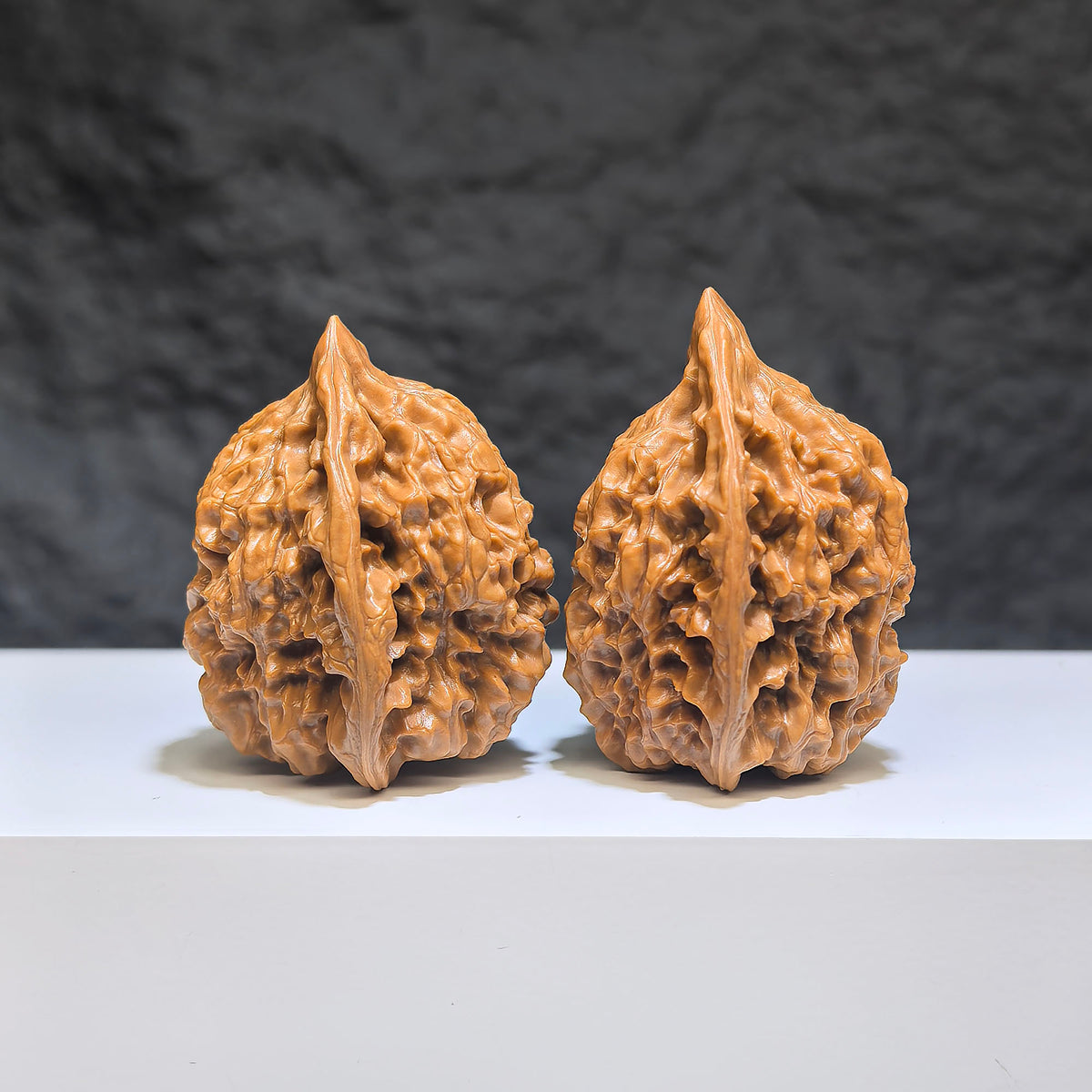 Small Wenwan Art official hat miniature walnut pair, 34mm x 33mm, featuring detailed carving and natural walnut wood grain.