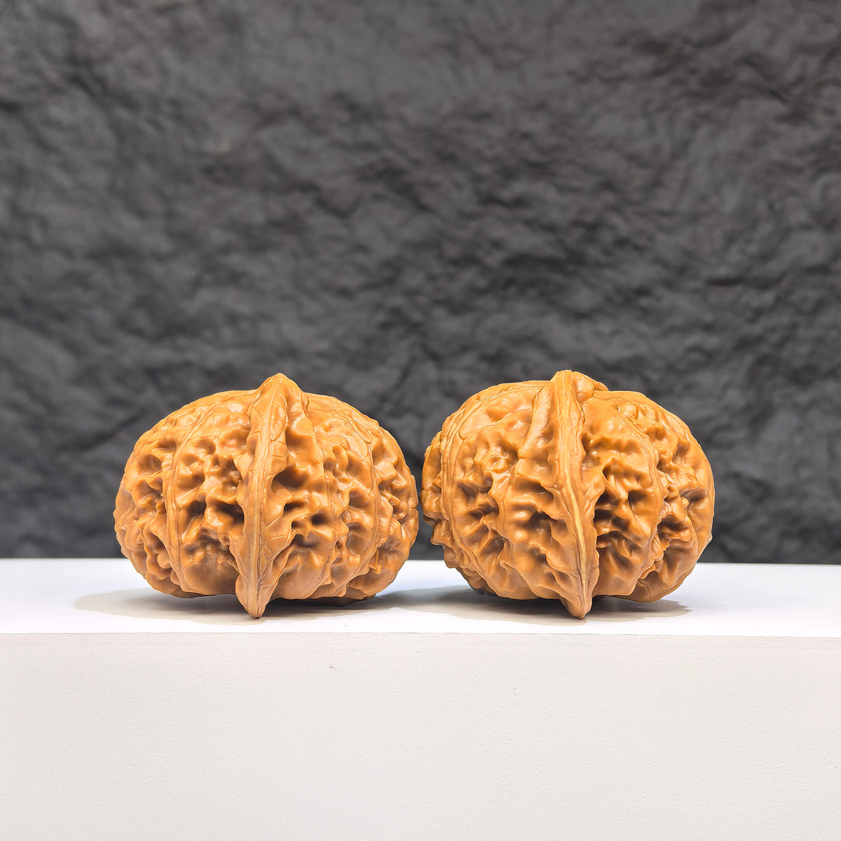 Pair of Palace Lantern Wenwan Walnuts from Wenwan Art, 42mm x 41mm, showcasing intricate carved designs on smooth walnut surfaces.