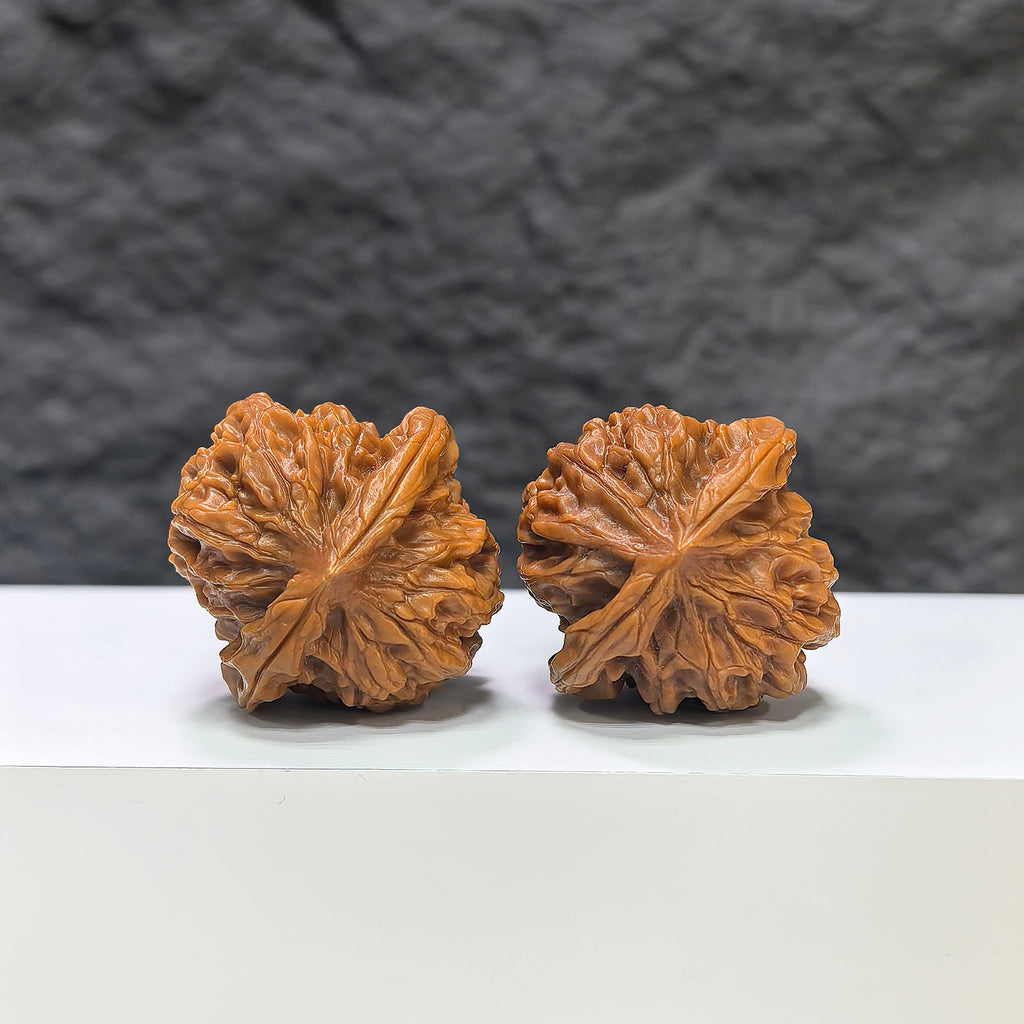 Wenwan Art Pocket Sizuolou miniature Wenwan walnut pair, 33mm, detailed carved walnut display on a plain background.