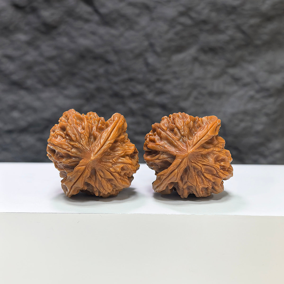 Wenwan Art Pocket Sizuolou miniature Wenwan walnut pair, 33mm, detailed carved walnut display on a plain background.