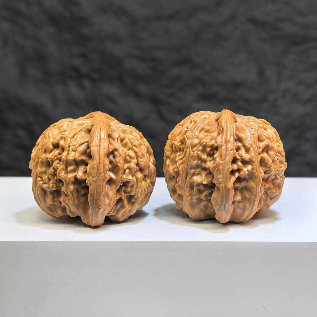 Pair of spherical white lion Wenwan walnuts from Wenwan Art, round profile, 44mm x 43mm, featuring detailed white lion carvings.