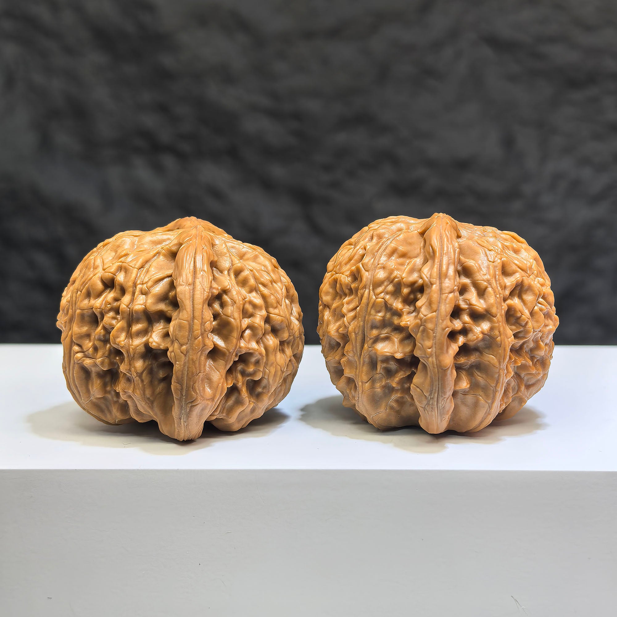 Pair of spherical white lion Wenwan walnuts from Wenwan Art, round profile, 44mm x 43mm, featuring detailed white lion carvings.