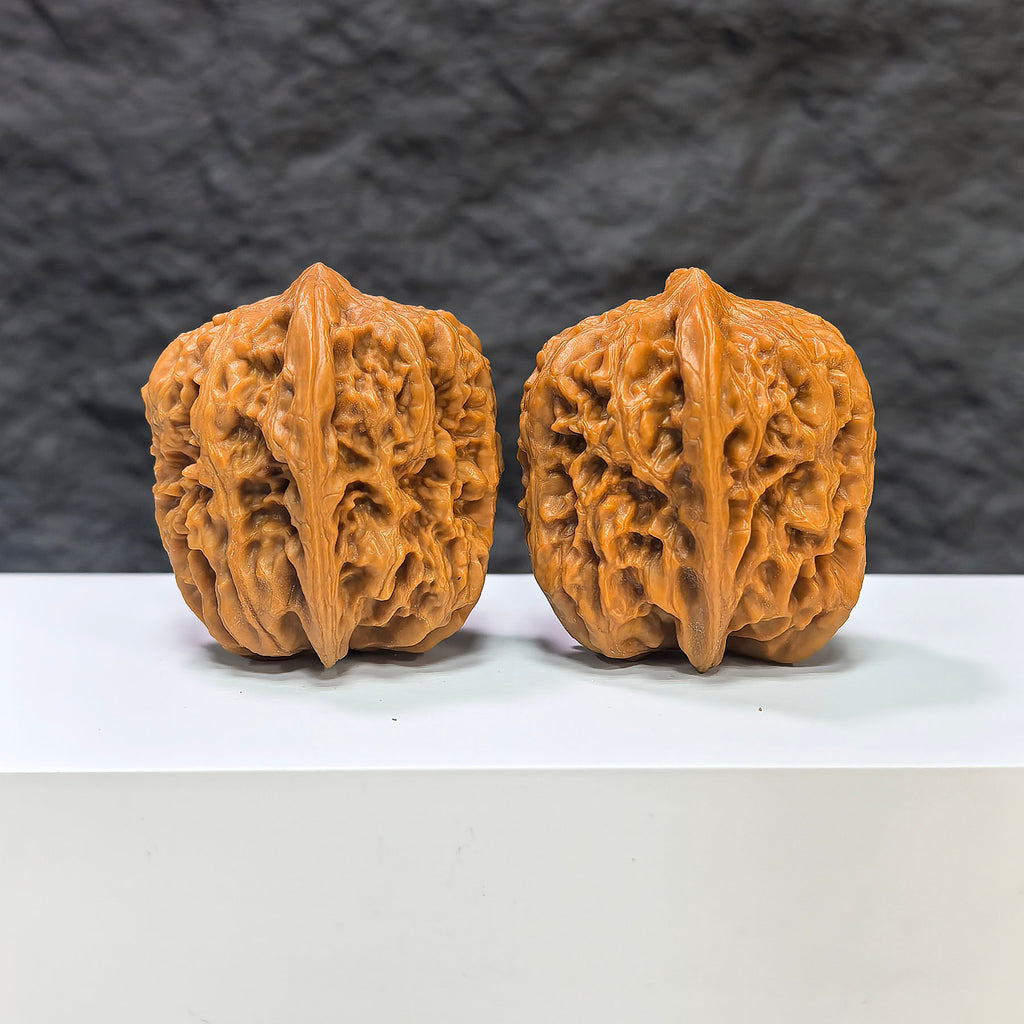 Pair of Pinggu Golden Hammer Wenwan walnuts from Wenwan Art, 39mm x 41mm, featuring smooth, polished walnut carvings.