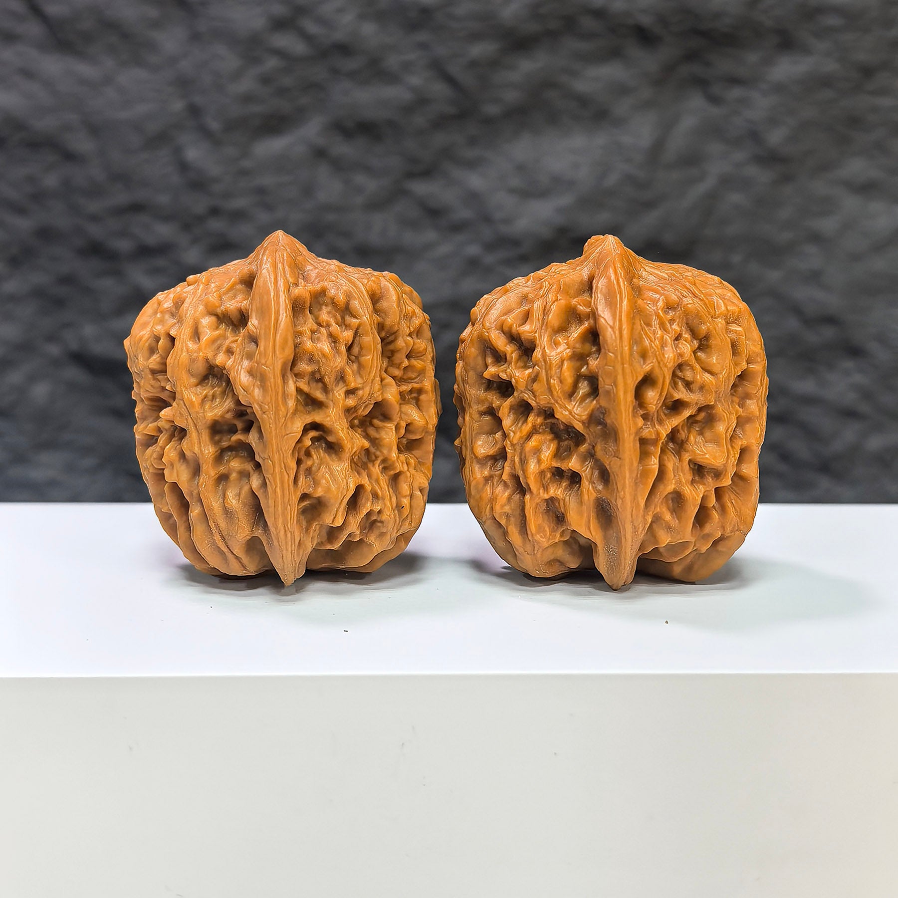 Pair of Pinggu Golden Hammer Wenwan walnuts from Wenwan Art, 39mm x 41mm, featuring smooth, polished walnut carvings.