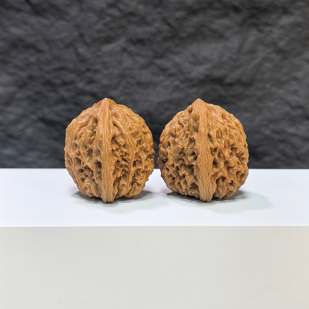 Pair of Nanjiangstone Wenwan walnuts by Wenwan Art, 36mm x 34mm, featuring smooth, polished surfaces and intricate natural stone patterns.