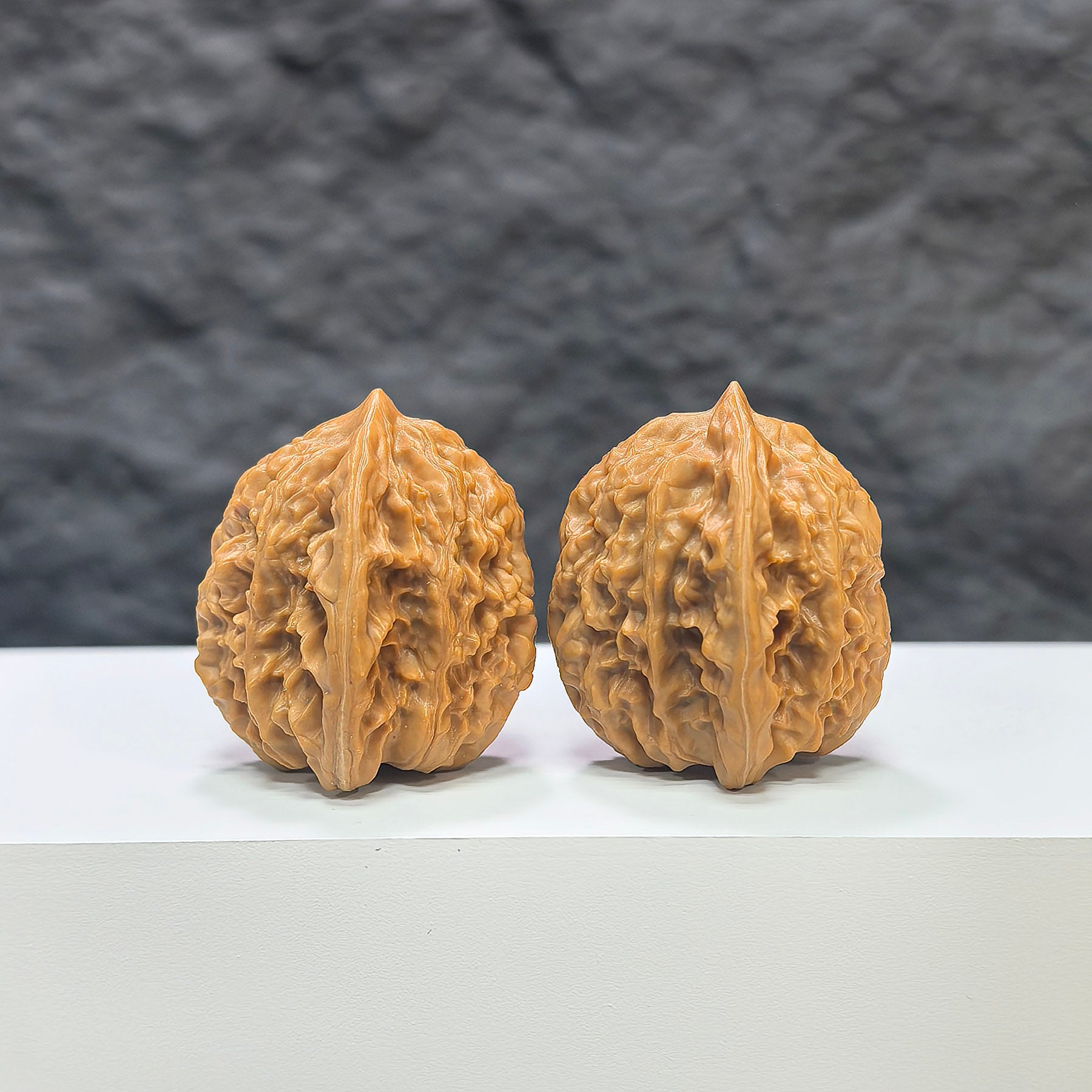 Pair of Xiayunling Pocket Wenwan walnuts by Wenwan Art, miniature 32mm x 31mm, showing detailed carved walnut surfaces.