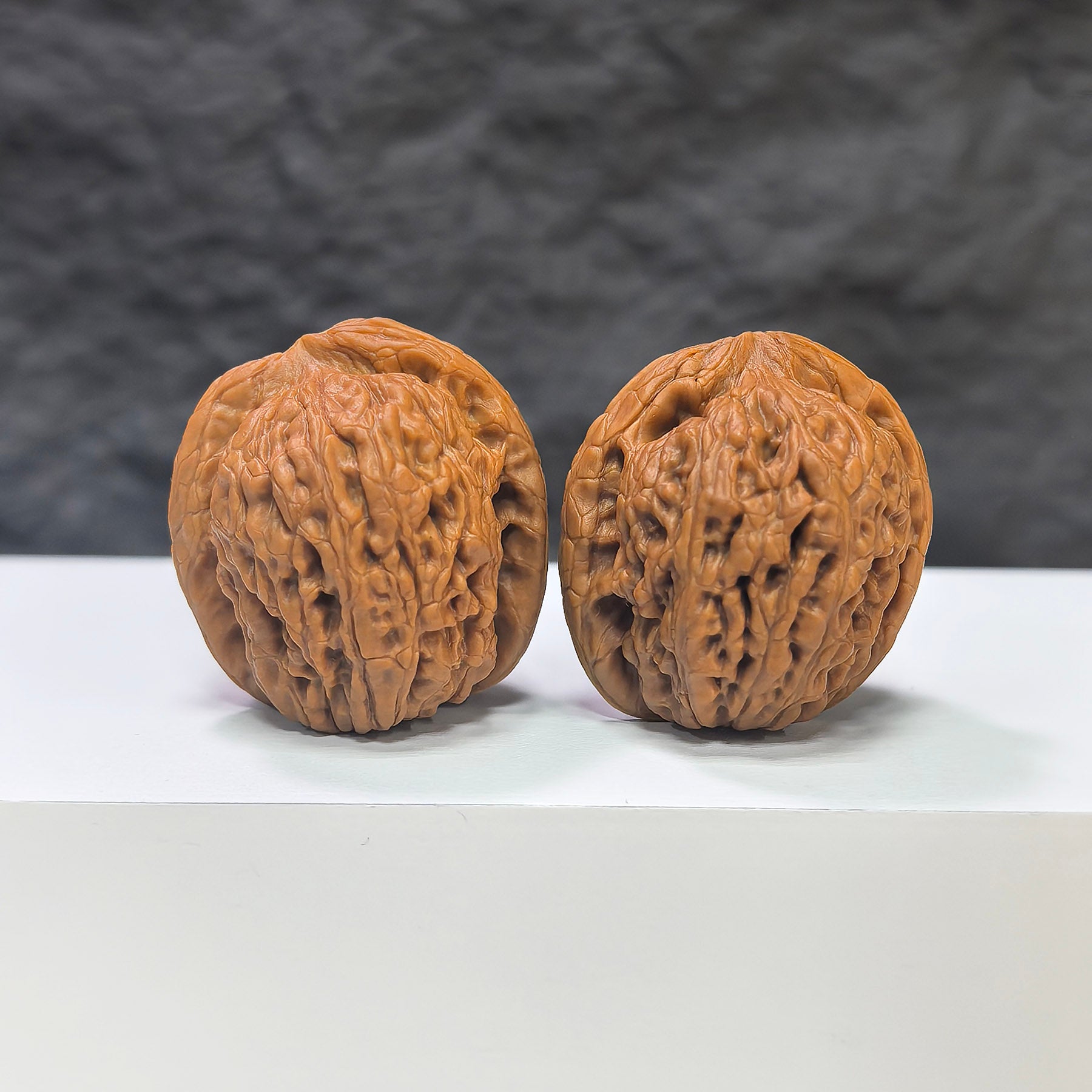 Pair of Wenwan Art Pocket Meteorite Sycee miniature walnuts, 30-31mm, featuring detailed natural stone textures and intricate craftsmanship.