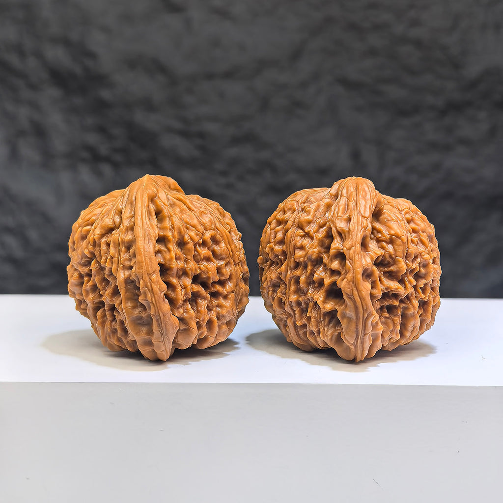 Pair of red shell Nanjiangstone Wenwan walnuts from Wenwan Art, 40mm x 38mm, showcasing smooth, polished surface and natural coloration.