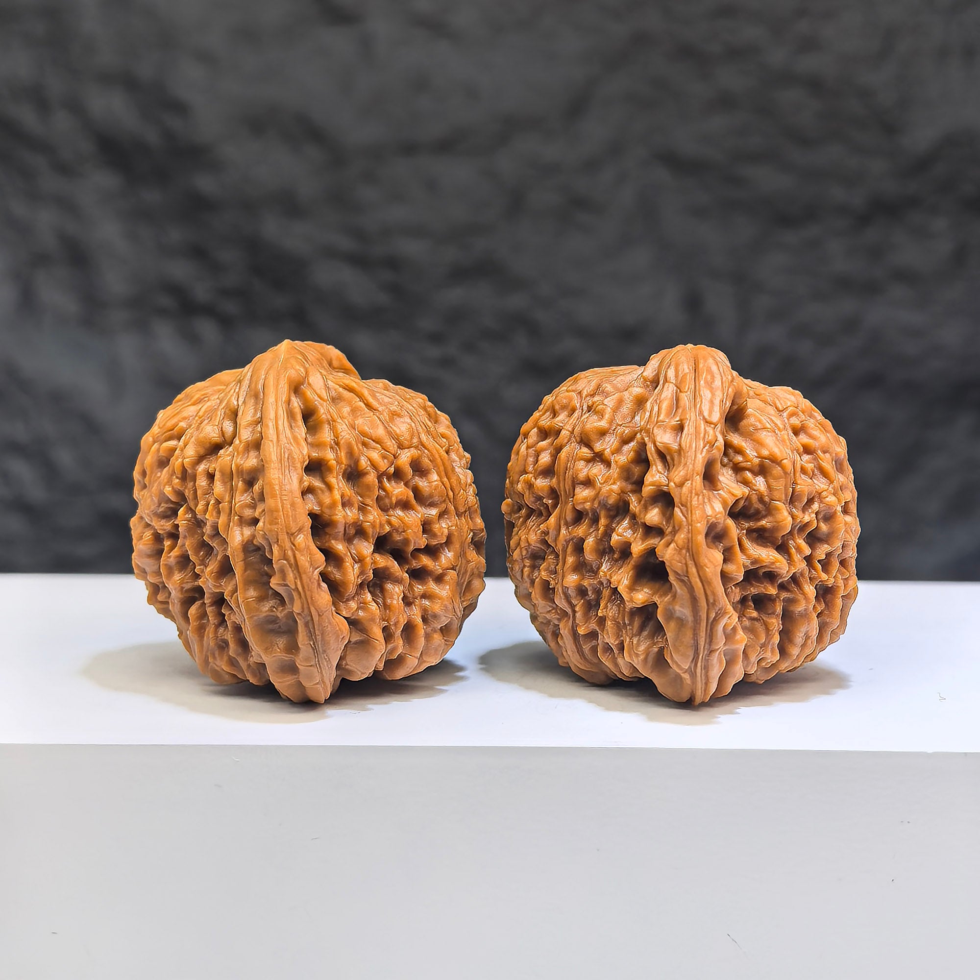 Pair of red shell Nanjiangstone Wenwan walnuts from Wenwan Art, 40mm x 38mm, showcasing smooth, polished surface and natural coloration.