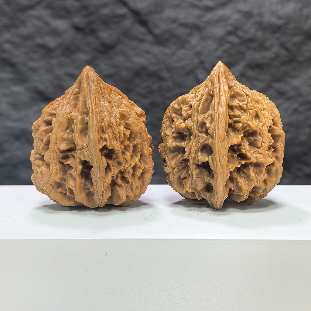 Pair of Dazhan Stone Wenwan walnuts from Wenwan Art, featuring smooth, polished surfaces with natural stone patterns, measuring 42x46mm.