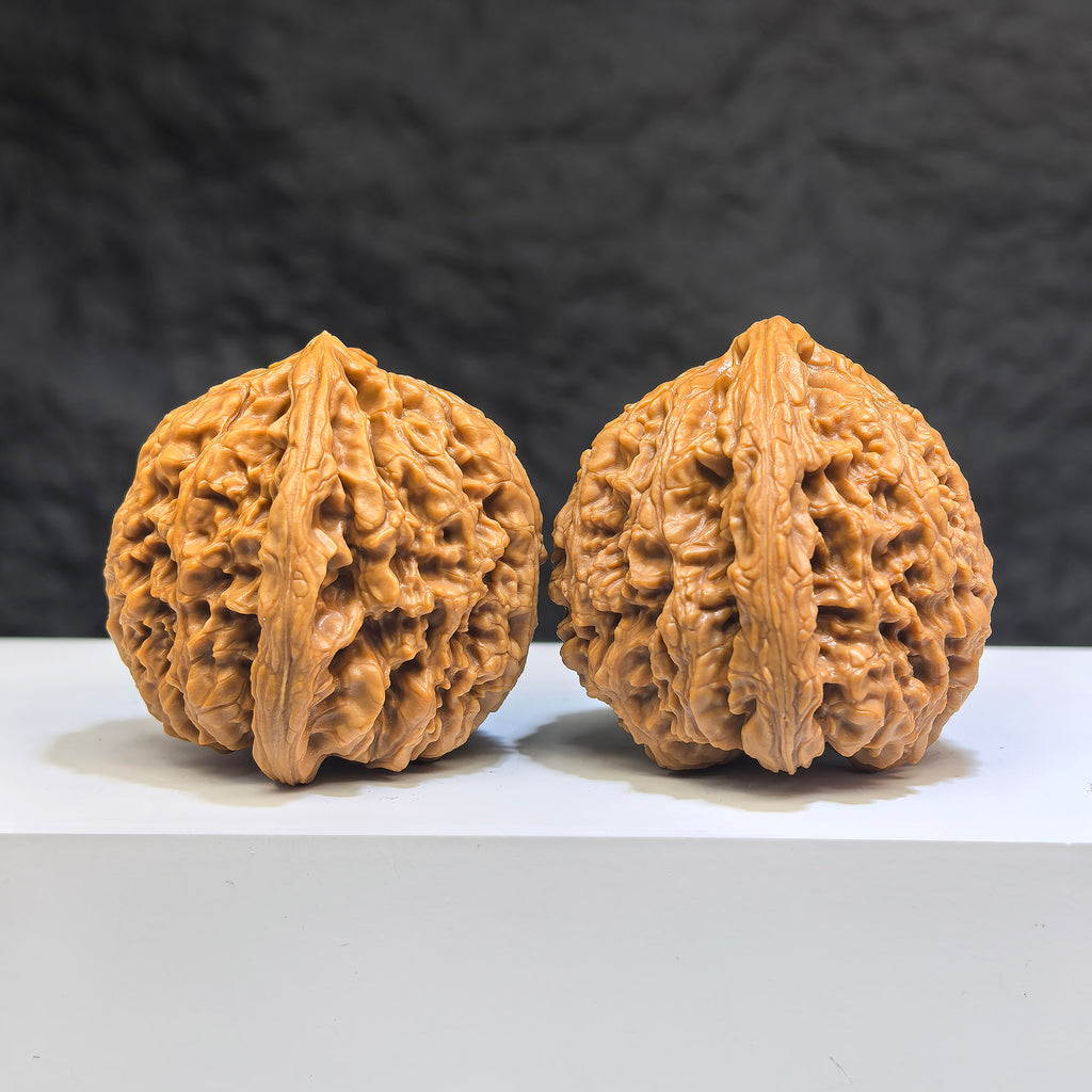Pair of Nanjiangstone Wenwan walnuts from Wenwan Art, 40mm diameter, showcasing smooth, polished natural stone with intricate patterns.