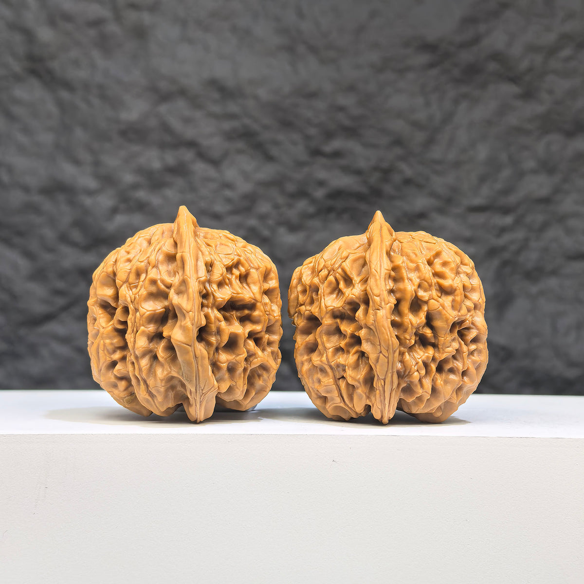 Pair of Wenwan Art Hundred Beasts Lion Head Wenwan walnuts featuring detailed lion head carvings, measuring 38mm by 36mm.