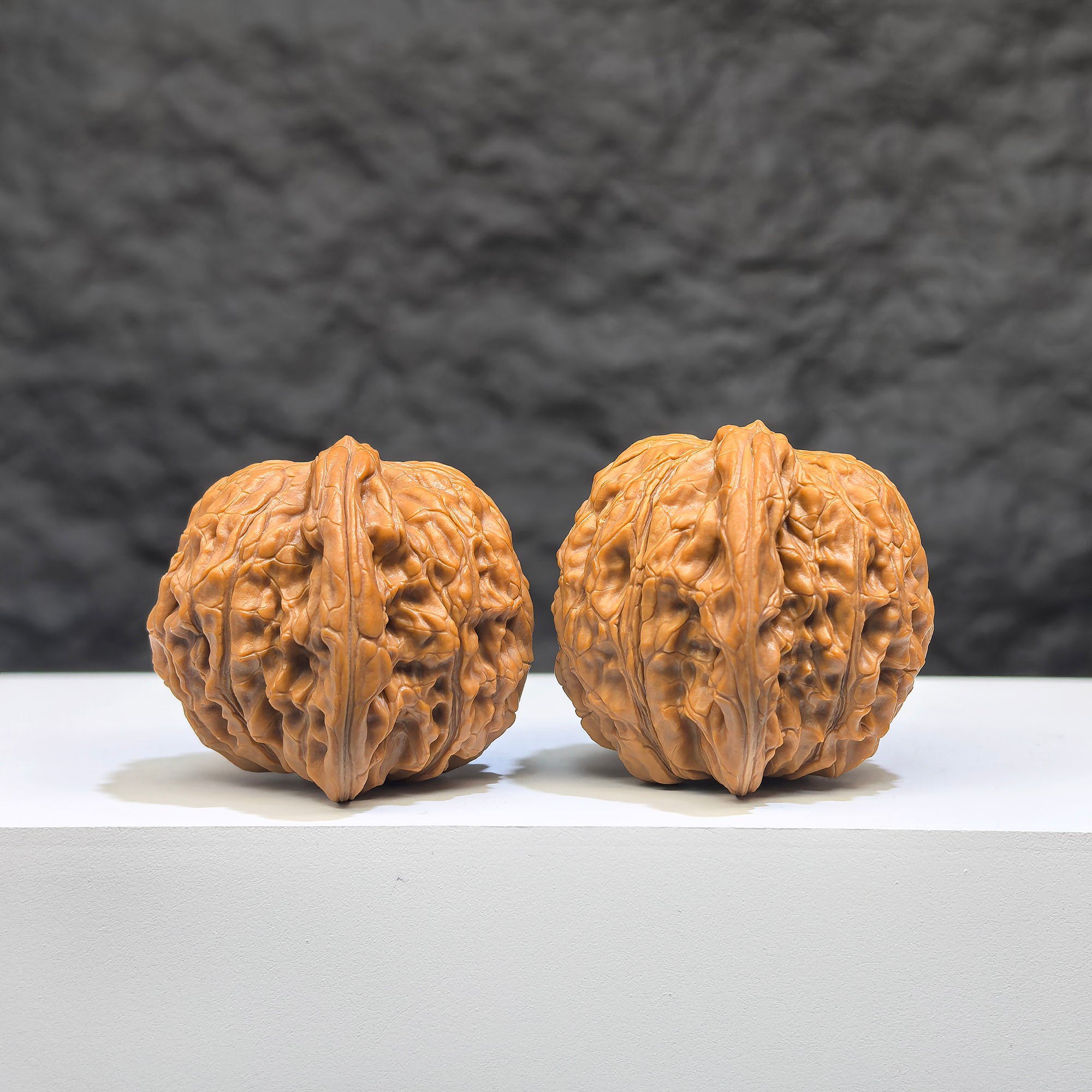 Pair of Wenwan Art Millstone Classic Wenwan walnuts, 38mm x 34mm, featuring detailed carved designs on smooth, polished surfaces.