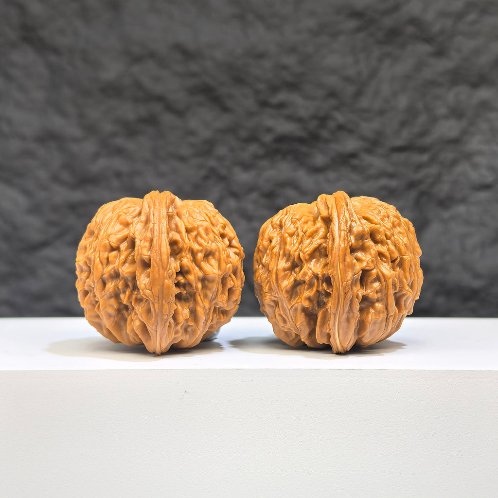 Pair of Wenwan Art Millstone Classic Wenwan Walnuts, 37mm x 35mm, featuring detailed carvings and traditional craftsmanship.