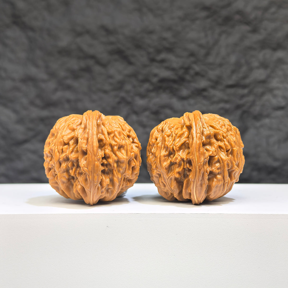 Pair of Wenwan Art Millstone Classic Wenwan Walnuts, 37mm x 35mm, featuring detailed carvings and traditional craftsmanship.